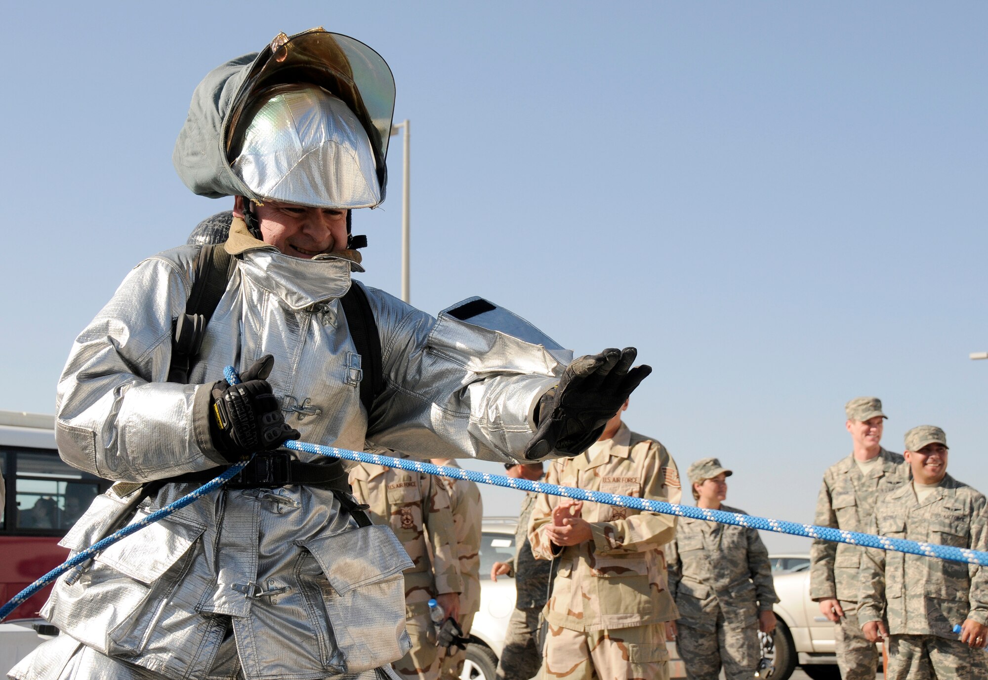 SOUTHWEST ASIA -- Col. Paul Murphy, 380th Air Expeditionary Wing vice commander, drags a 5-inch diameter, 50-foot hose over 100 feet during the 380th Firefighter Challenge held Dec. 20 here. The Firefighter Challenge gave Airmen the opportunity to don firefighter gear and be timed while performing various physical tasks. (U.S. Air Force photo/Tech. Sgt. Christopher A. Campbell)(released)