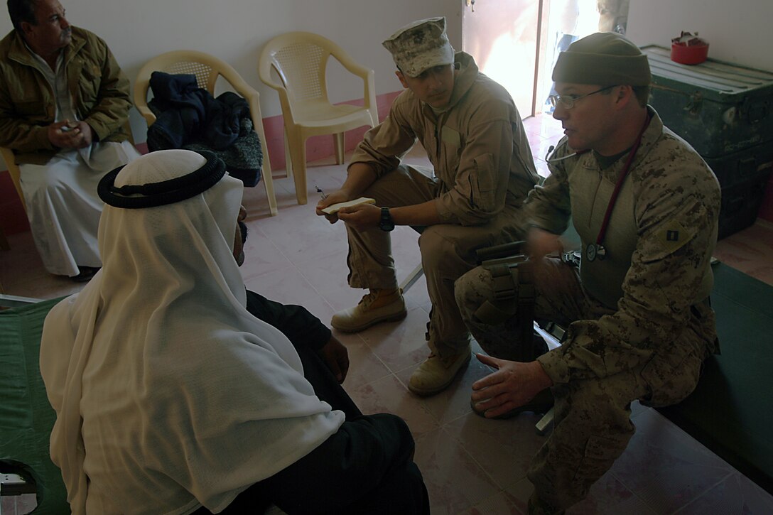 Navy Lt. Scott N. Margraf, medical officer, Security Force, Marine Wing Support Squadron 373, 1st Marine Logistics Group, sees to the ailments of Iraqis at the new Kabani medical clinic here Dec. 20. Margraf, 42, Sasebo, Japan, was one of a few doctors present for the clinic?s ribbon cutting ceremony and subsequent medical engagement. The new Kabani Medical Clinic provides a venue for future medical engagements and Iraqi doctors to use to treat Kabani?s population. Engaging with the populace is critically important to mission accomplishment in Iraq, said Margraf. Kabani, a small village just east of Camp Taqaddum, used to host civil affairs engagements and visits from their own Iraqi medical practitioners in whatever structures they had available. Through a combination of diplomatic action from Iraqi and Coalition Forces, the village now has a necessary venue for health care. The combined medical engagement was one of many 1st MLG has performed since taking over for 2nd MLG in February of this year. The new clinic in Kabani marks the first of many recent steps toward improvements of Iraqi infrastructure.