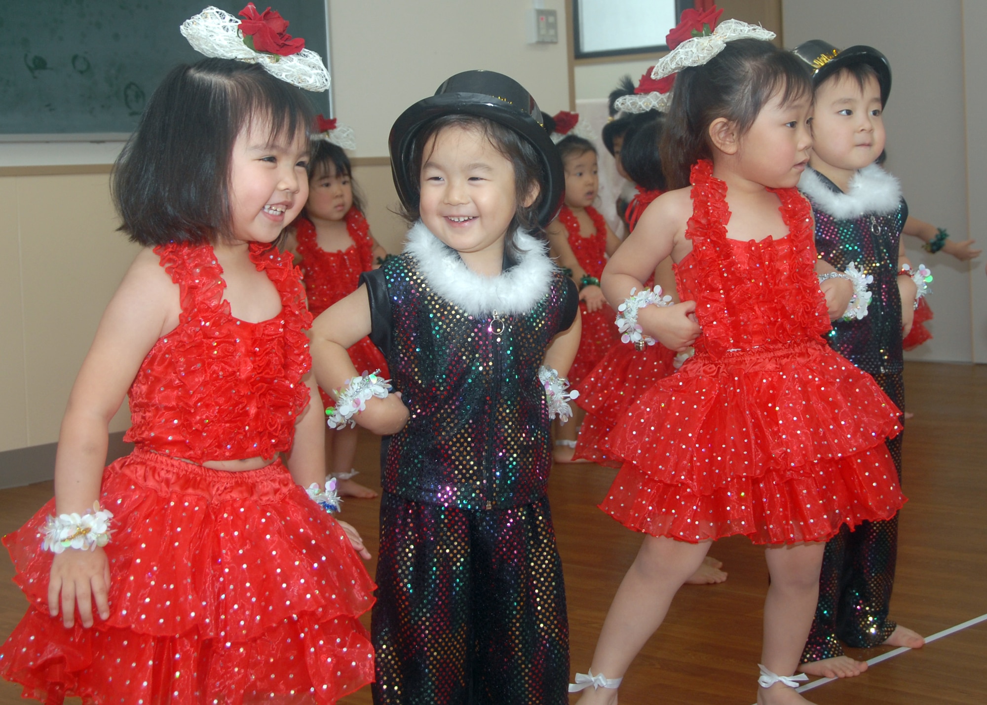 MISAWA AIR BASE, Japan -- As part of celebrating the Christmas season, children of Misawa Municipal Chuo Child Care Center dance for their classmates, teachers, Misawa Company Grade Officers Council, and Santa Claus, Dec. 18. 2008. The CGOC along with Staff Sgt. Jonathan Moeller, vehicle operations dispacher, 35th Logistics Readines Squadron, handed out candycanes and posed for pictures with more than 150 students. (U.S. Air Force photo by 2nd Lt. Jeff M. Nagan)