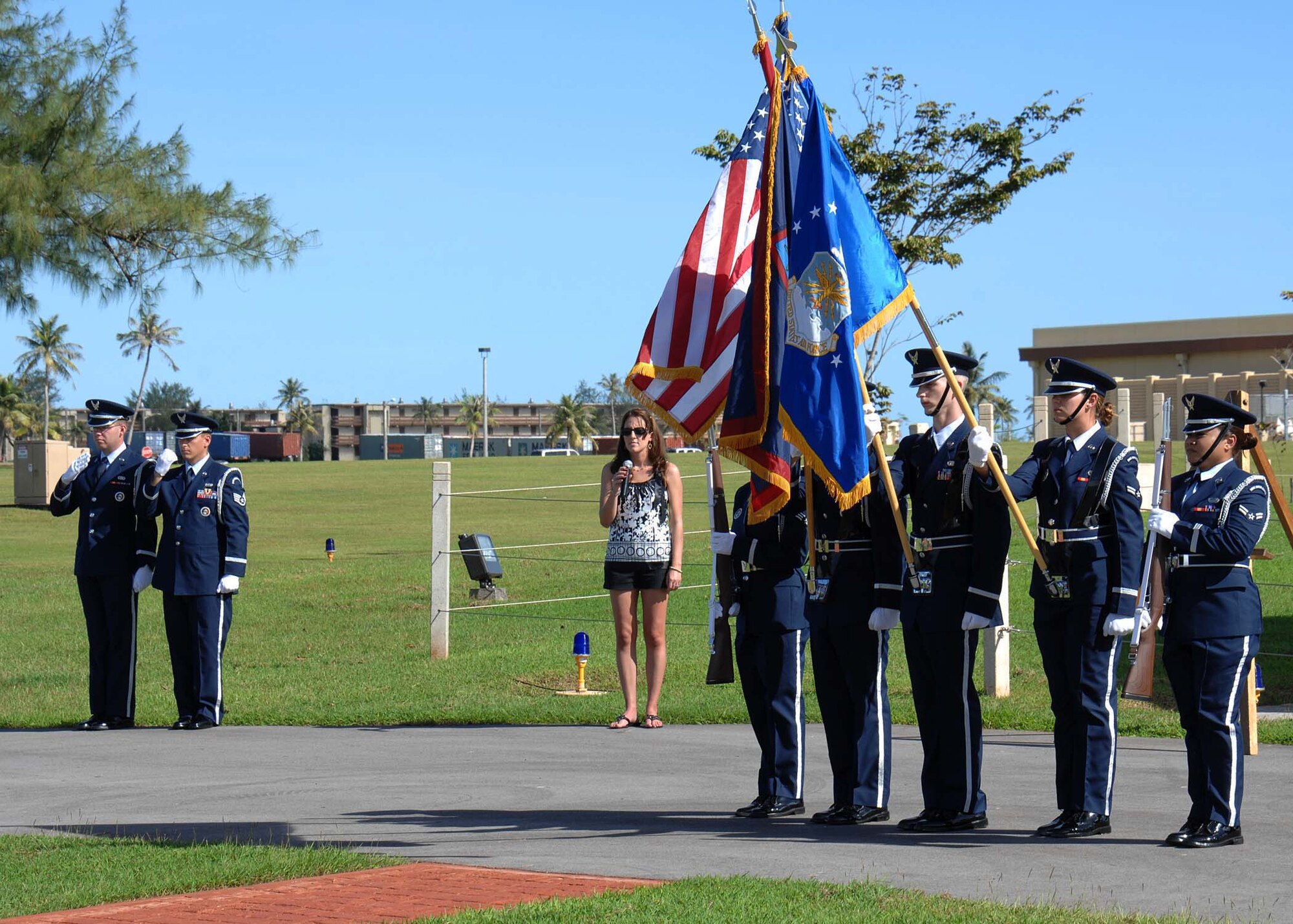 ANDERSEN AIR FORCE BASE, Guam -- The Team Andersen Honor Guard present the flags as Airman 1st Class Heather Wells, 36th Operations Support Squadron, sings the National Anthem at the Arc Light Memorial Park here for the Operation Linebacker II Ceremony Dec. 18. Members of the 36th Expeditionary Bomb Squadron sponsored this year's ceremony, commemorating its 36th anniversary. (U.S. Air Force photo by Senior Airman Sonya Croston)