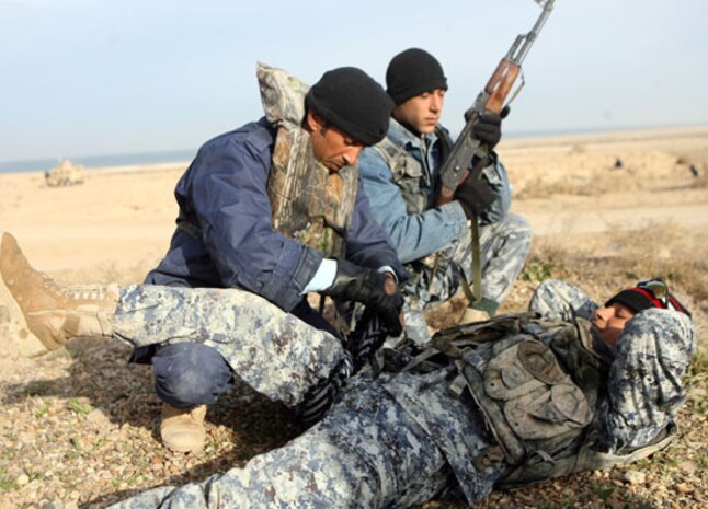 Police officers training to be officers with the al-Anbar Iraqi River Police conduct an extraction procedure while applying first aid to a simulated casualty Dec 21 at Lake Thar Thar, Iraq. The police officers took part in a week-long training course with sailors from Detachment 3, Riverine Squadron 1, Regimental Combat Team 5. ::r::::n::