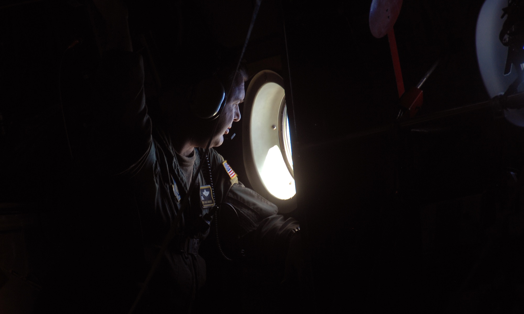 Chief Master Sgt. Michael Sundberg, views a drop zone from a C-130 Hercules, Dec.19 during Operation Christmas Drop. Airmen today continue the tradition, delivering supplies to remote islands of the Commonwealth of the Northern Marianas Islands, Yap, Palau, Chuuk and Pohnpei. Over 600 pounds of donated goods were dropped over the remote islands during Operation Christmas Drop. Chief Sundberg is a loadmaster from the 36th Airlift Squadron, Yokota AB, Japan. (U.S. Air Force photo/ Master Sgt. Kevin J. Gruenwald) released