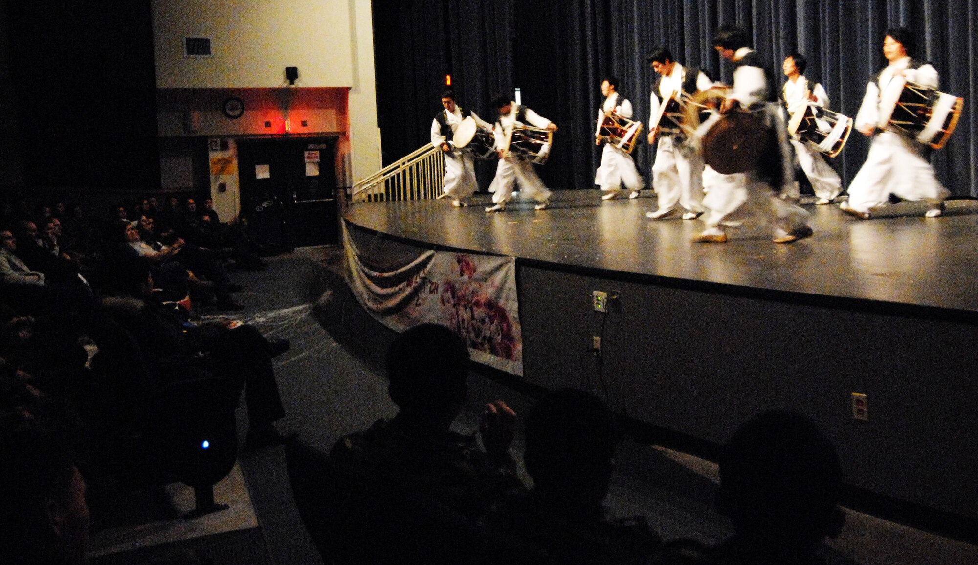 Kusan Airmen watch a Korean drum performance during the Republic of Korea Air Force sponsored end of year performance at the Kunsan Air Base theater, Dec. 22, 2008. Airmen from the Wolf Pack were invited to attend a night of music, dance and magic.  (U.S. Air Force Photo by Senior Airman Gustavo Gonzalez)