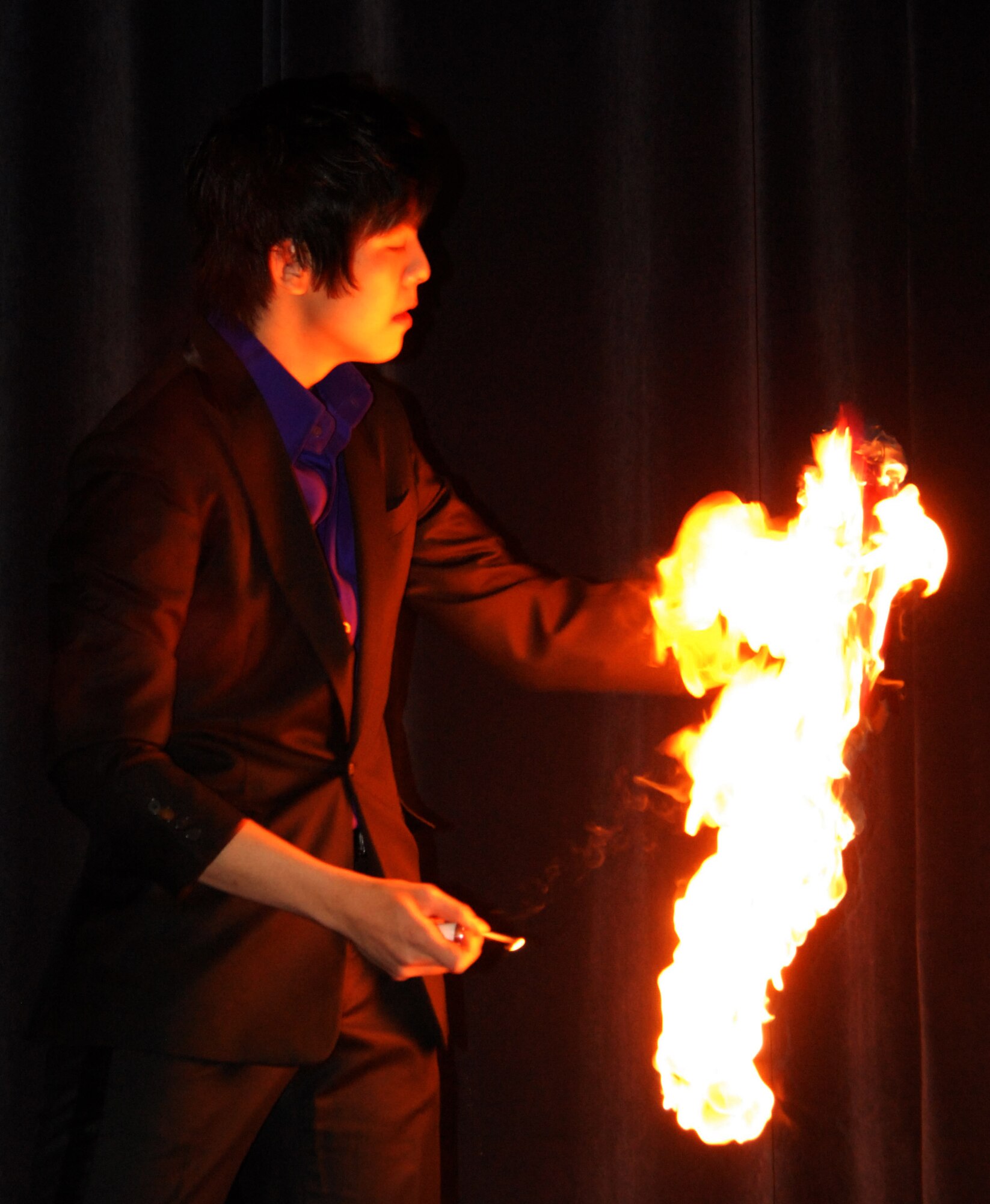 A Korean magician displays a little bit of his magic during the Republic of Korea Air Force sponsored end of year performance at the Kunsan Air Base theater, Dec. 22, 2008. Airmen from the Wolf Pack were invited to attend a night of music, dance and magic. (U.S. Air Force Photo by Senior Airman Gustavo Gonzalez)