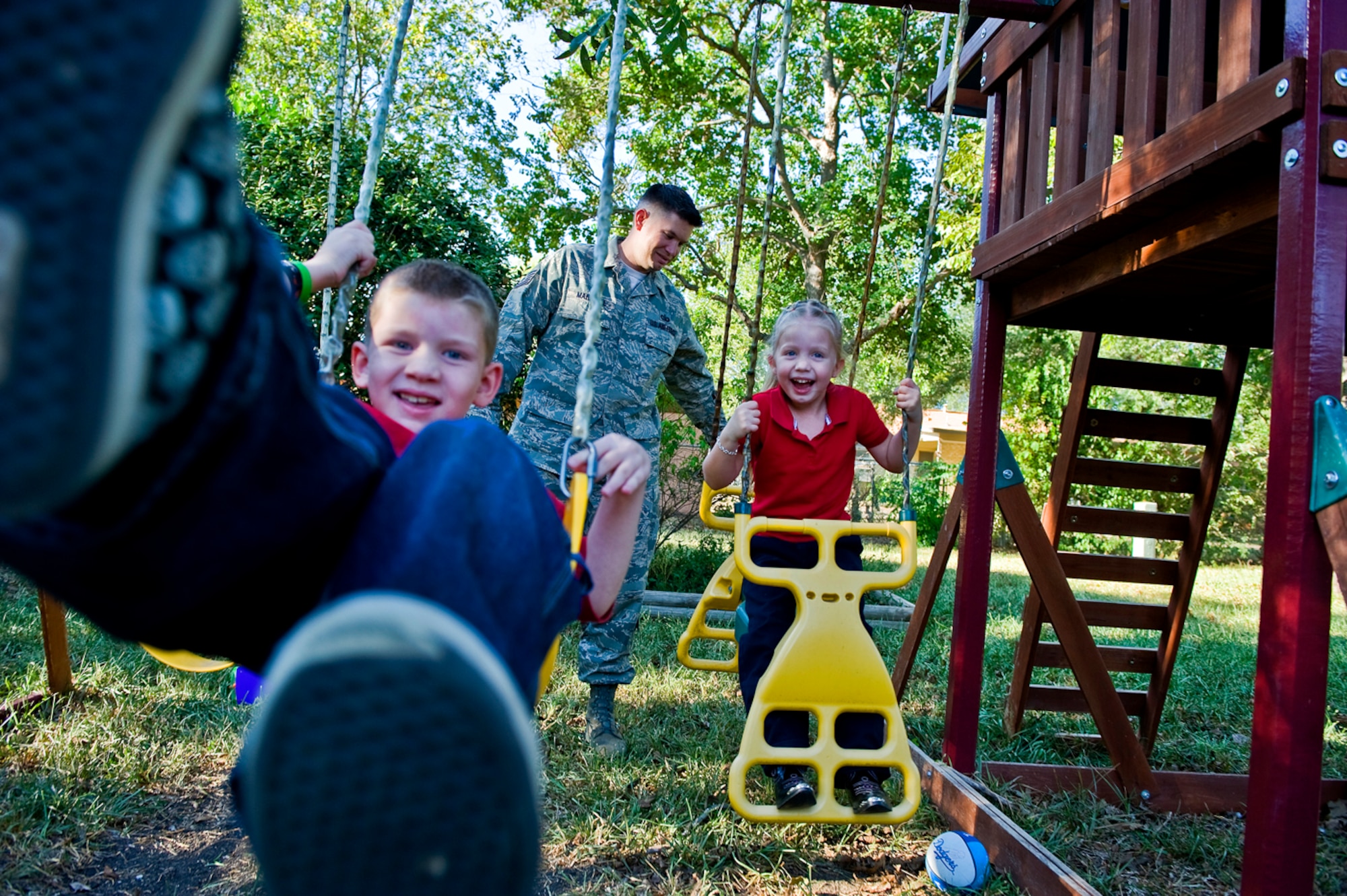 Partially paralyzed on his left side, Justin doesn't let that slow him down as he plays here with his sister, Makenna and his dad, Tech. Sgt. James Marshall. (U.S Air Force Photo by Tech Sgt. Matthew Hannen)