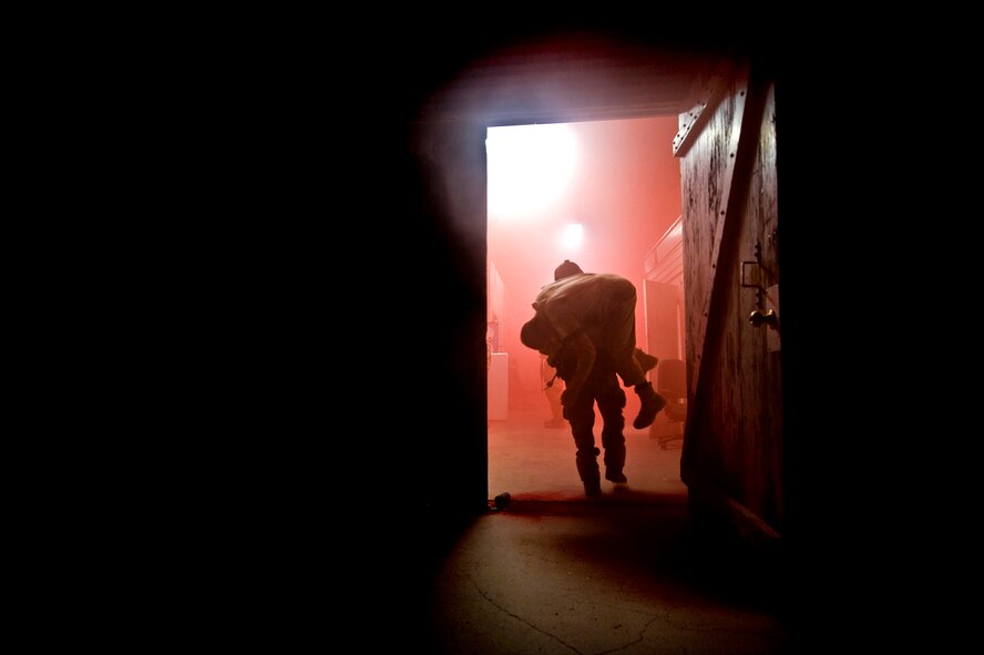 Pararescue students work as fast as they can during a mass casualty exercise that simulated an explosion on a base at 4 in the morning. Rogers carries an injured Airman to safety and then works feverishly to treat the injuries. (U.S Air Force Photo by Tech Sgt. Matthew Hannen)