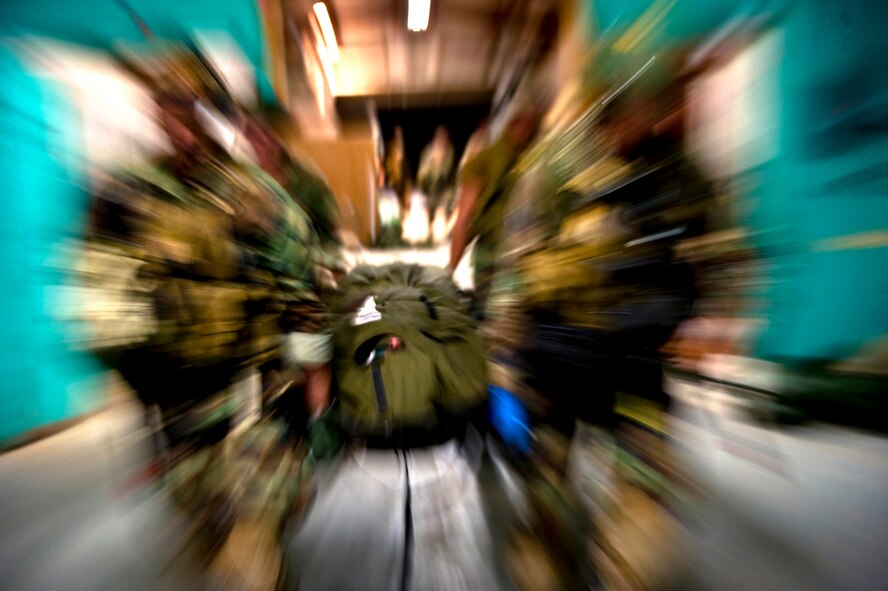 Students carry a wounded warrior on a litter as they rush to a safe area to administer medical care. Pararescue students work as fast as they can during a mass casualty exercise that simulated an explosion on a base at 4 in the morning. The number of wounded can be overwhelming in this realistic training scenerio. (U.S Air Force Photo by Tech Sgt. Matthew Hannen)