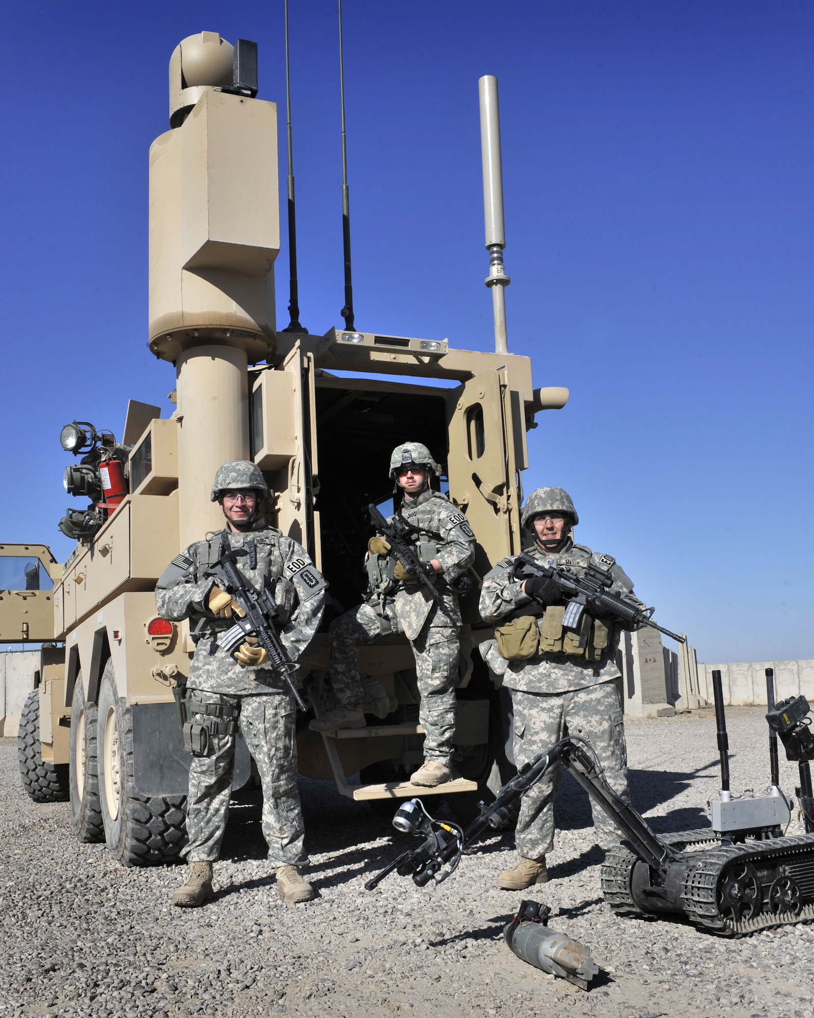 Explosive Ordnance Disposal Team One, Airman 1st Class Derrick Torba, Staff Sgt. Michael Breive and Tech. Sgt. Jeffrey Wasik, take a moment out of their busy schedule to pose in front of a Joint explosive ordnance disposal rapid response vehicle or JERRV Dec. 17 at Sather Air Base, Iraq. All three are EOD technicians assigned to the 447th Expeditionary Civil Engineer Squadron Explosive Ordnance Disposal Flight, Alpha (U.S. Air Force photo/Master Sgt. Brian Davidson)