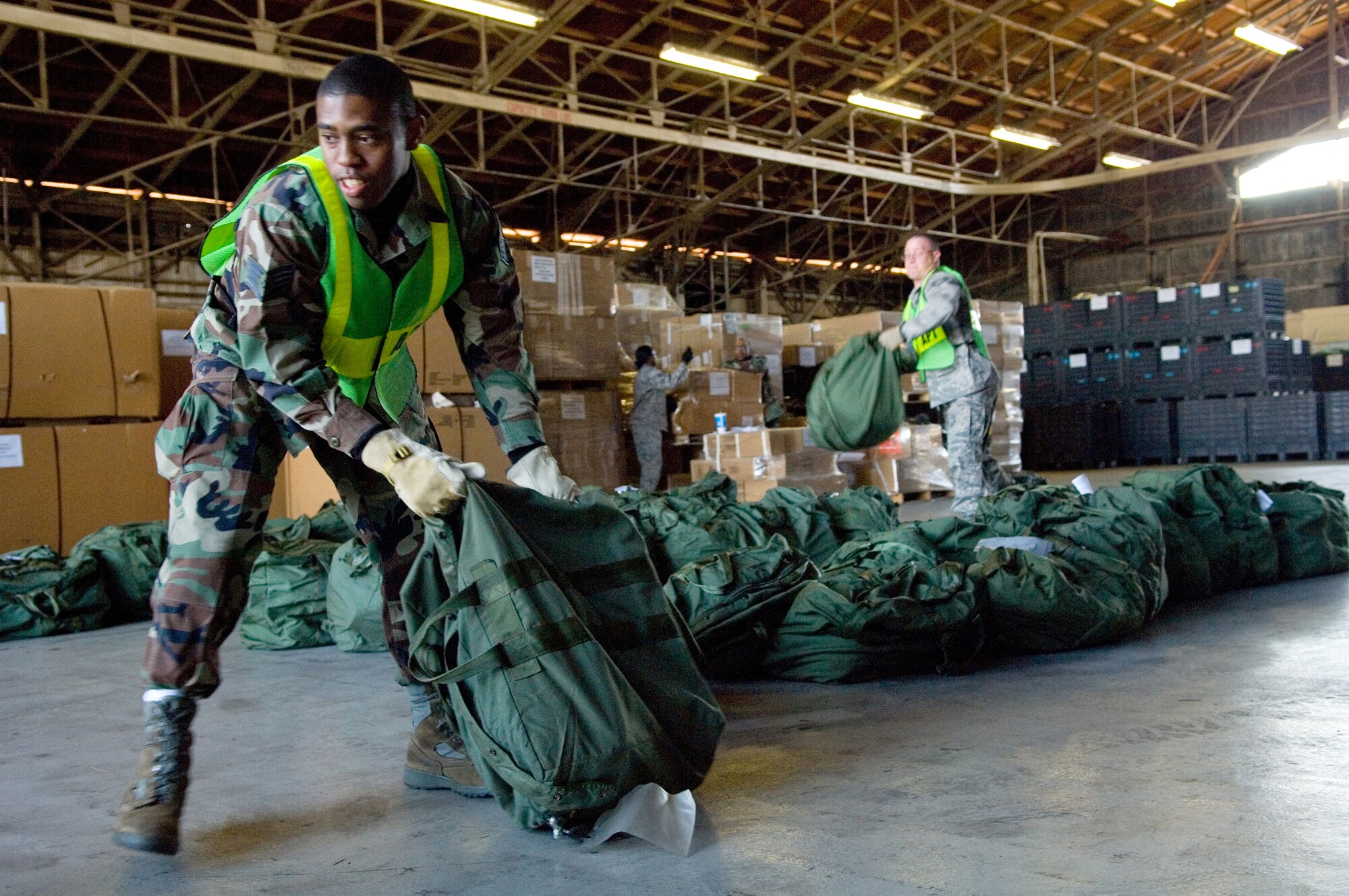 YOKOTA AIR BASE, Japan- Staff Sgt. Timothy Smith, 374th Logistics Readiness Squadron, loads luggage on to a pallet during the Samurai Readiness cargo loading training here, Dec.19. (U.S. Air Force Photo by Osakabe Yasuo)