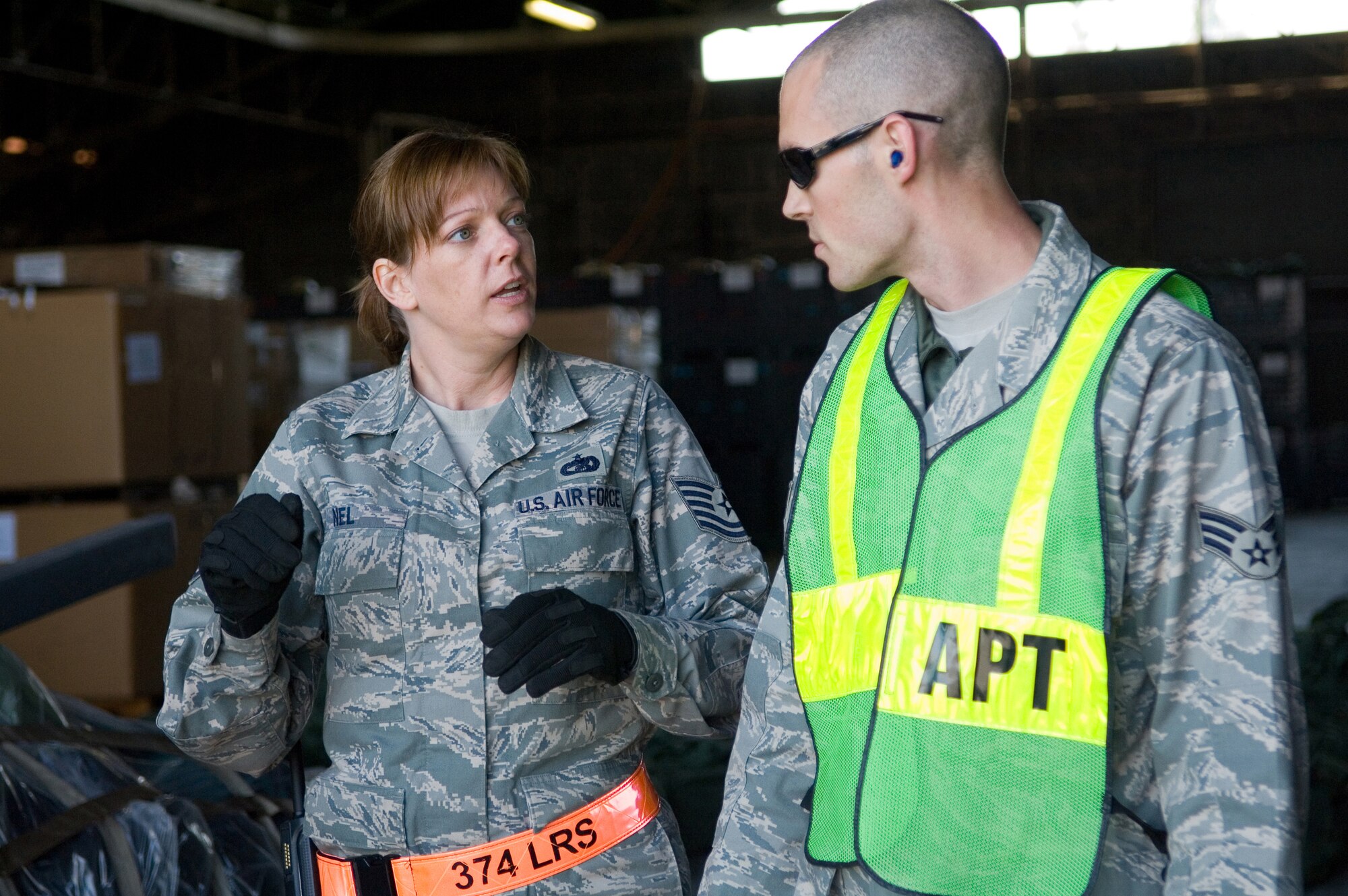 YOKOTA AIR BASE, Japan- Tech. Sgt. Sherri Nel, 374th Logistics Readiness Squadron, instructs Senior Airman Richard Mast (Right) how to direct the forklift during the Samurai Readiness cargo loading training here, Dec.19. (U.S. Air Force Photo by Osakabe Yasuo)