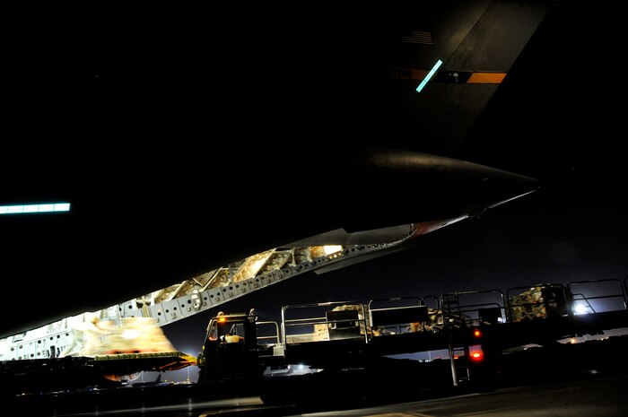 Airmen unload cargo from the back of a C-17 Globemaster III Nov. 19 at an air base in Southwest Asia. The C-17 has been delivering cargo to and from different bases in the area of responsibility in support of Operation Iraqi Freedom. (U.S. Air Force photo/Staff Sgt. Darnell T. Cannady) 