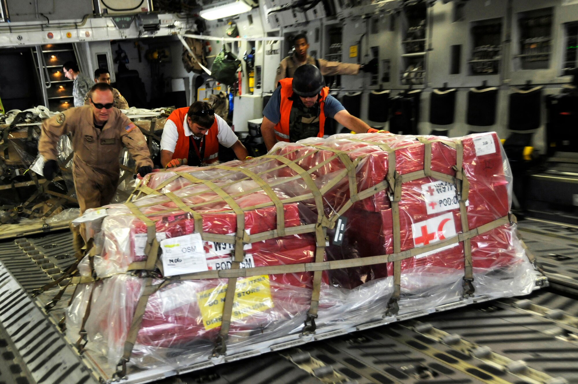 Airmen unload cargo from the back of a C-17 Globemaster III Nov. 19 at Mosul Air Base, Iraq. The C-17 has been delivering cargo to and from different bases in the area of responsibility in support of Operation Iraqi Freedom. (U.S. Air Force photo/Staff Sgt. Darnell T. Cannady) 
