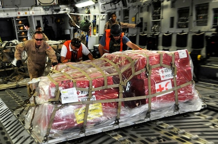 Airmen unload cargo from the back of a C-17 Globemaster III Nov. 19 at Mosul Air Base, Iraq. The C-17 has been delivering cargo to and from different bases in the area of responsibility in support of Operation Iraqi Freedom. (U.S. Air Force photo/Staff Sgt. Darnell T. Cannady) 
