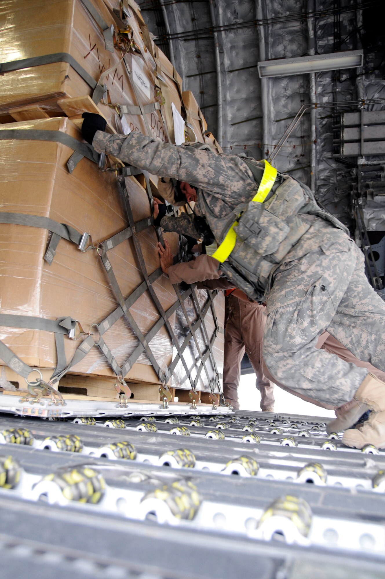 Airmen unload cargo from the back of a C-17 Globemaster III Nov. 19 at Mosul Air Base, Iraq. The C-17 has been delivering cargo to and from different bases in the area of responsibility in support of Operation Iraqi Freedom. (U.S. Air Force photo/Staff Sgt. Darnell T. Cannady) 
