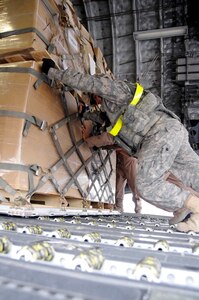 Airmen unload cargo from the back of a C-17 Globemaster III Nov. 19 at Mosul Air Base, Iraq. The C-17 has been delivering cargo to and from different bases in the area of responsibility in support of Operation Iraqi Freedom. (U.S. Air Force photo/Staff Sgt. Darnell T. Cannady) 
