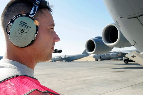 Senior Airman Eric Miller performs a preflight inspection of a C-17 Globemaster III Nov. 19 at an air base in Southwest Asia. Airman Miller is a communications technician assigned to the 8th Expeditionary Air Mobility Squadron responsible for ensuring the C-17 is capable of flying and carrying out its mission. Airman Miller, a native of Chicago, is deployed from Charleston Air Force Base, S.C. (U.S. Air Force photo/Staff Sgt. Darnell T. Cannady) 