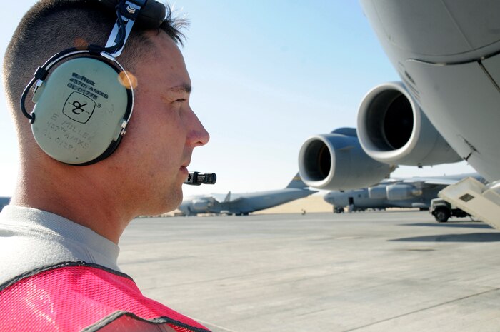 Senior Airman Eric Miller performs a preflight inspection of a C-17 Globemaster III Nov. 19 at an air base in Southwest Asia. Airman Miller is a communications technician assigned to the 8th Expeditionary Air Mobility Squadron responsible for ensuring the C-17 is capable of flying and carrying out its mission. Airman Miller, a native of Chicago, is deployed from Charleston Air Force Base, S.C. (U.S. Air Force photo/Staff Sgt. Darnell T. Cannady) 
