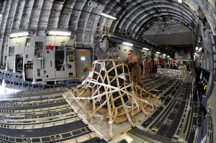 Airmen unload cargo from the back of a C-17 Globemaster III Nov. 19 at Mosul Air Base, Iraq. The C-17 has been delivering cargo to and from different bases in the area of responsibility in support of Operation Iraqi Freedom. (U.S. Air Force photo/Staff Sgt. Darnell T. Cannady) 
