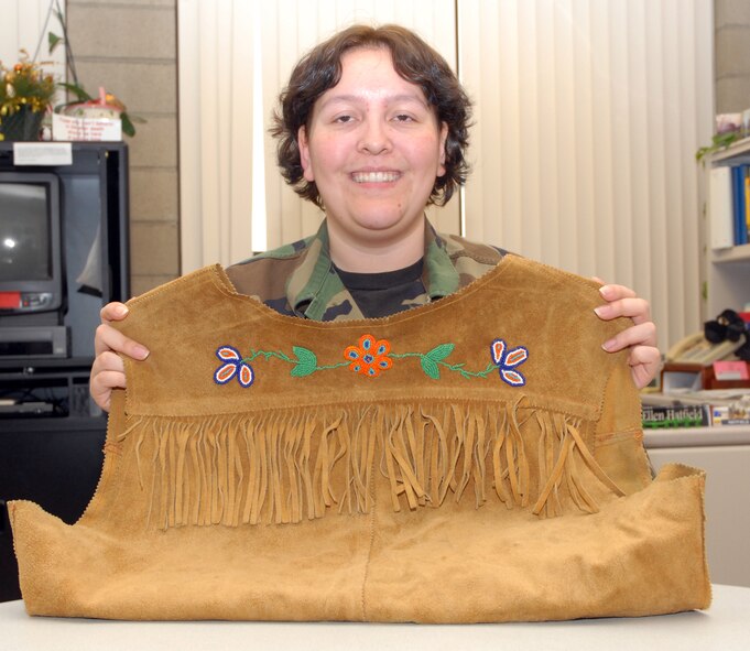 BEALE AIR FORCE BASE, Calif. -- Air Force Reservist Staff Sgt. Josephine Coy with the 940th Air Refueling Wings Command Post shows off a Native American hand-beaded vest that belonged to her great grandfather. She received the family heirloom from her father.  Staff Sgt. Coy was selected as the 940th ARW Citizen Warrior of the month.  (U.S.  Air Force Photo/ Tech. Sgt. Luke Johnson)