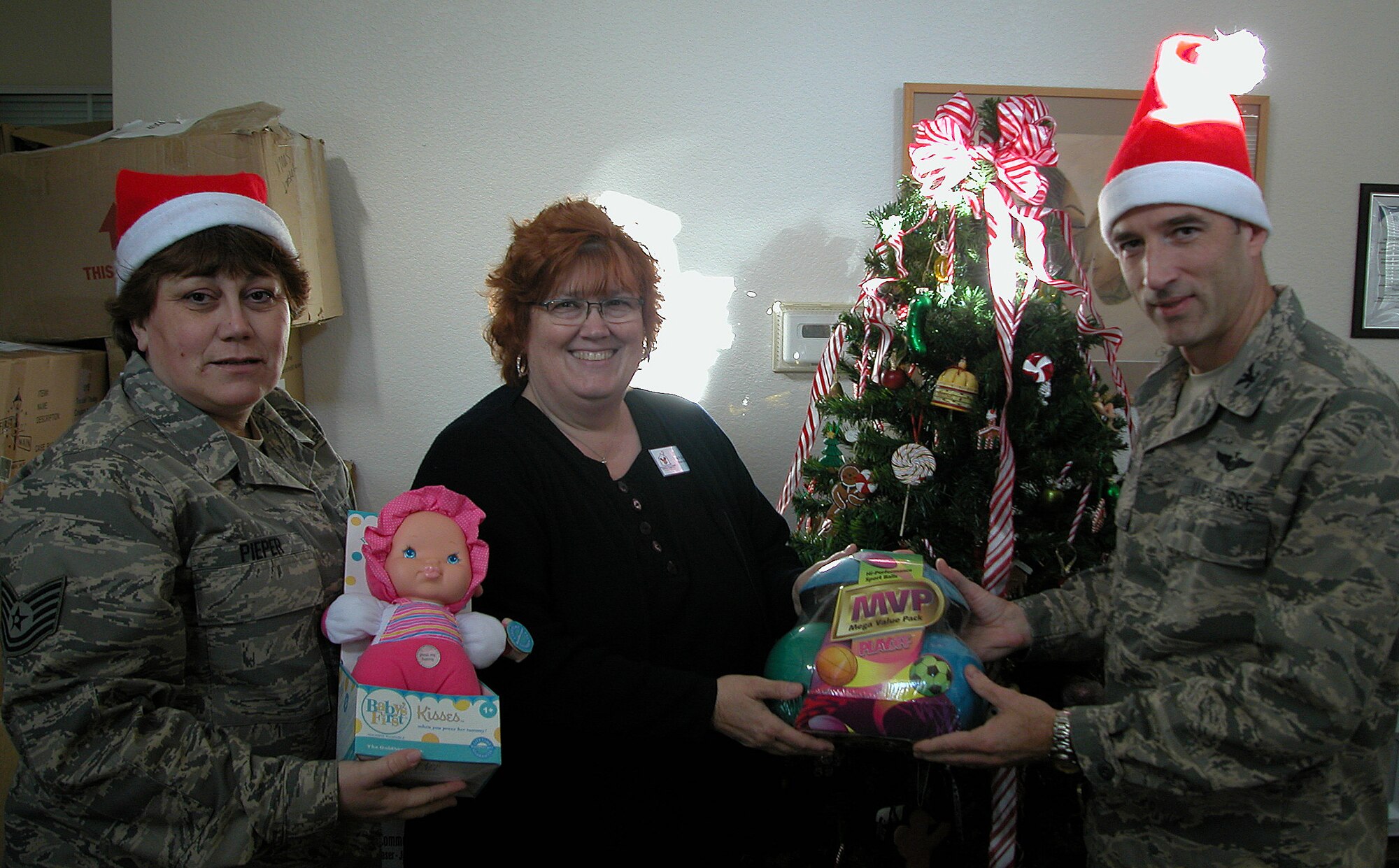 SACRAMENTO, Calif. -- Air Force Reservists, Col. Jeffrey "Sal" Mineo, 940th Air Refueling Wing Commander, and Tech. Sgt. Laurie Pieper with 940th ARW Airman and Family Readiness, pose for a photo with Lois Polaschek, Ronald McDonald house manager, showing off some of the toys Airmen from 940th ARW at Beale Air Force Base, Calif. donated. The Sacramento Ronald McDonald House is a nonprofit organization that offers family members of seriously ill and injured children comfort and support in a home-away-from-home environment. (Courtesy Photo)  