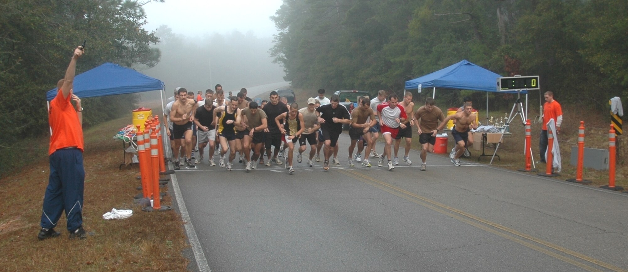 Runners sprint from the starting line at the first Eglin/Hurlburt Cross Country Challenge  Dec. 19 at the Timberlake Recreation area near Eglin AFB. The Hurlburt Team won the meet by being the first team to have five runners complete the five-mile course. First, second and third place trophies were awarded to the top finishing squadrons and went to the Air Force Special Operations Command Special Tactics Training Squadron, 6th Special Operations Squadron and the AFSOC headquarters team, respectively. (U.S. Air Force photo /2nd Lt. Mark Lazane) 