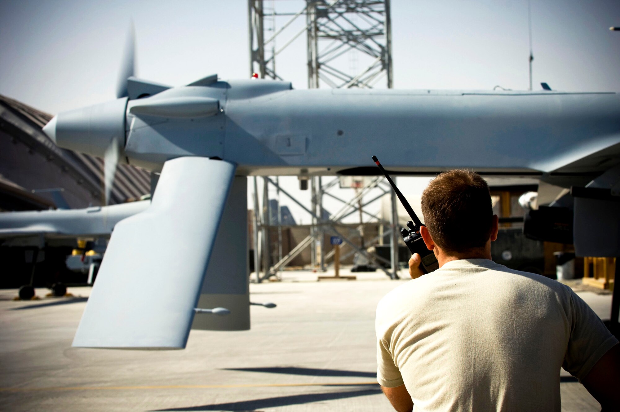 Airman 1st Class Justin Cole monitors the engine and propeller of an MQ-1 Predator as it starts up Oct. 26 at a base in southern Afghanistan. With the pilot and sensor operator inside the ground control station, they rely heavily on communication via radio with crew chiefs to have a successful launch. Airman Cole is a 62nd Expeditionary Reconnaissance Squadron crew chief deployed from Creech Air Force Base, Nev. He hails from Orange Park, Fla. (U.S. Air Force photo/Staff Sgt. Samuel Morse) 
