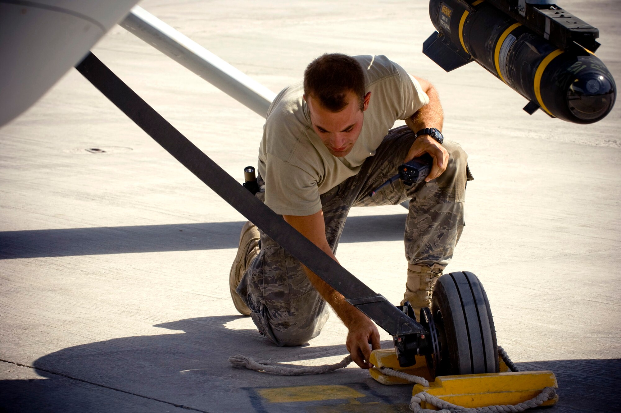 Airman 1st Class Justin Cole removes the chalks of an MQ-1 Predator Oct. 26 at a base in southern Afghanistan. Despite the unmanned, remote nature of the aircraft, they are still treated with all the same precautions and considerations of the larger, manned airframes. Airman Cole is a 62nd Expeditionary Reconnaissance Squadron crew chief deployed from Creech Air Force Base, Nev. He hails from Orange Park, Fla. (U.S. Air Force photo/Staff Sgt. Samuel Morse) 
