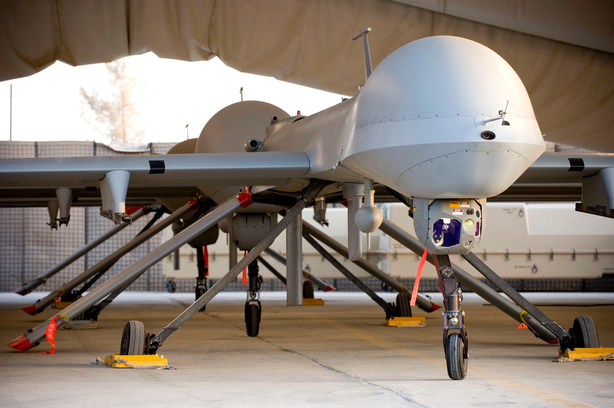 Three MQ-1 Predators sit ready for launch in a hangar Oct. 25 at a base in southern Afghanistan. The Predator is a multirole attack reconnaissance unmanned aircraft system incorporating advanced surveillance capabilities with the offensive power of two AGM-114 Hellfire missiles. (U.S. Air Force photo/Staff Sgt. Samuel Morse)
