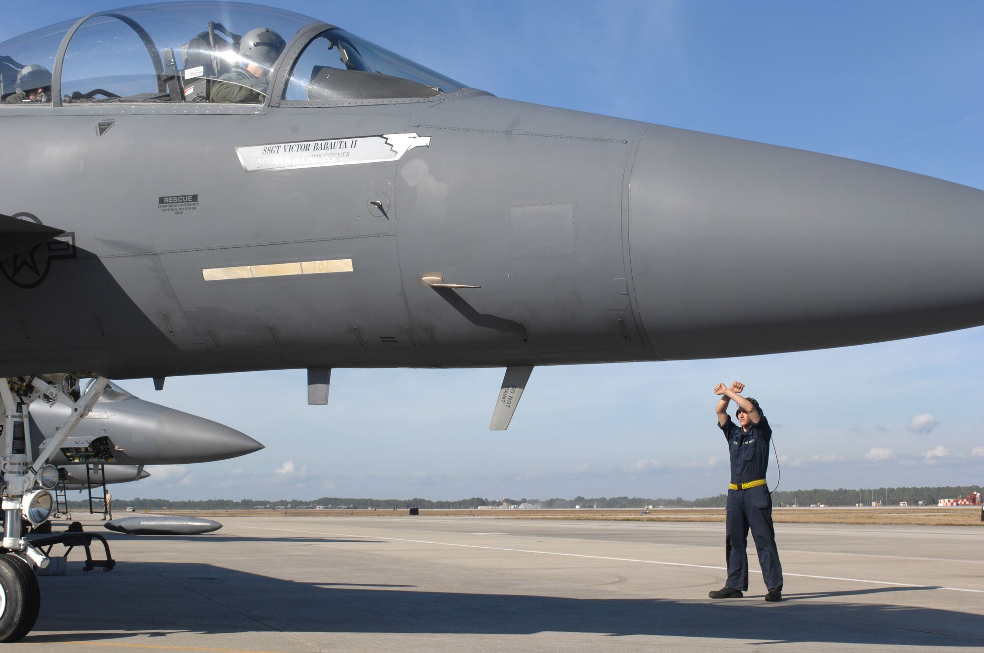 Airman 1st Class James Jaromack, a 336th Aircraft Maintenance Unit crew chief, marshals an F-15E Strike Eagle to a stop at Tyndall Air Force Base, Fla., Dec. 18. The 336th Fighter Squadron and associated maintenance personnel completed the two week air-to-air combat evaluation called Combat Archer Dec. 19. (U.S. Air Force photo by Staff Sgt. Shawn J. Jones)