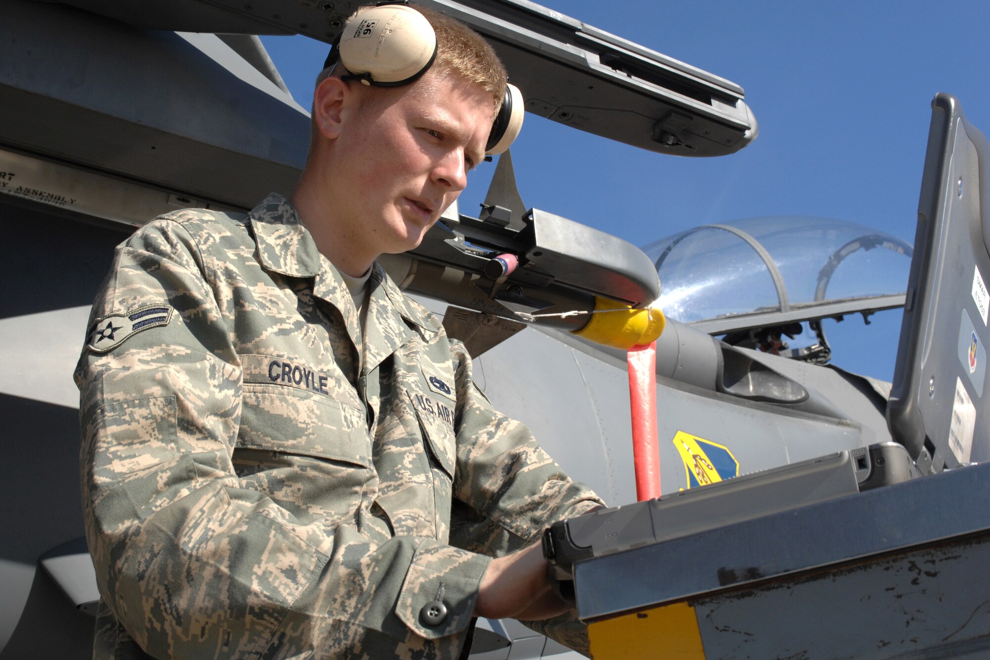 Airman 1st Class Timothy Croyle, a 336th Aircraft Maintenance Unit weapons specialist, reads technical orders from his maintenance laptop while working on an F-15E Strike Eagle at Tyndall Air Force Base, Fla., Dec. 18.The 336th Fighter Squadron and associated maintenance personnel completed the two-week air-to-air combat evaluation called Combat Archer Dec. 19. (U.S. Air Force photo by Staff Sgt. Shawn J. Jones)