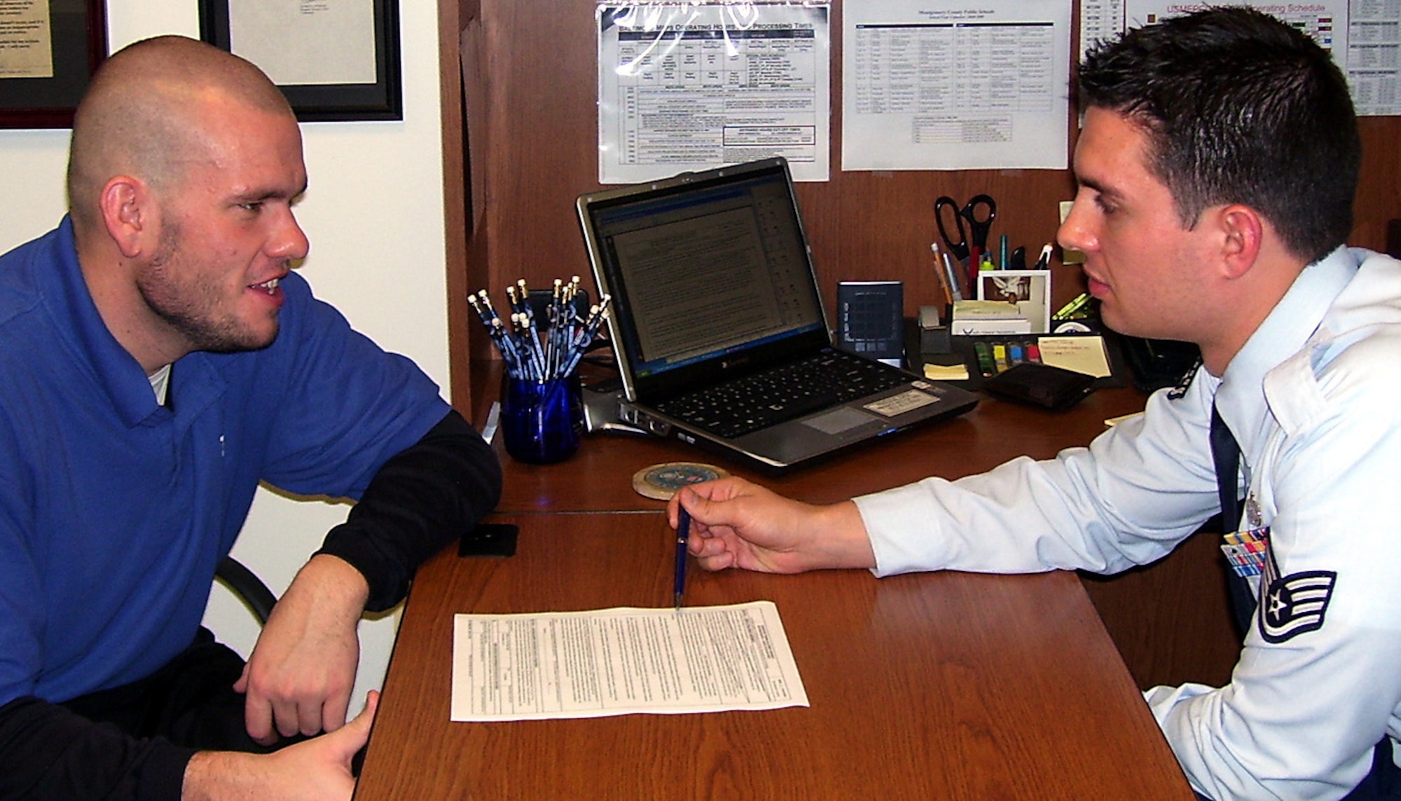 Leo Knight-Inglesby reviews his Air Force enlistment contract Dec. 10 with his recruiter, Staff Sgt. Ty Lopez, in the Rockville, Md., recruiting office. About 15 months earlier, when the 22-year-old from Silver Spring, Md., decided that he wanted to join the Air Force, he weighed 351 pounds and didn't meet physical standards. Today, he is fit and 160 pounds lighter, and is preparing to attend basic military training in the spring. (U.S. Air Force photo/Staff Sgt. Ty Lopez)