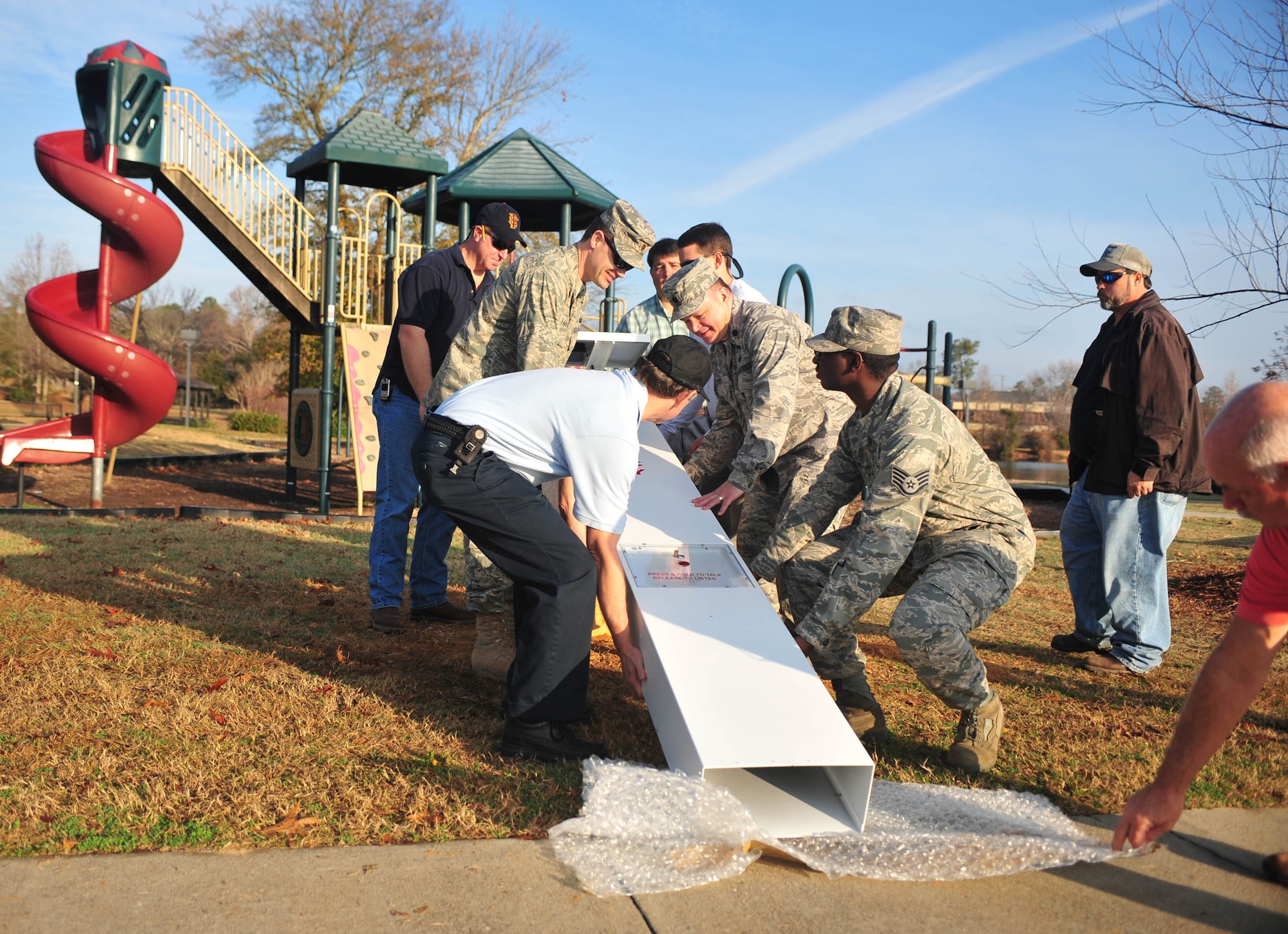 SHAW AIR FORCE BASE, S.C. -- Base personnel alongside civilian contractors prepare to install the new emergency system on Shaw AFB.  In case a caller is distressed, upon activation, a digitally stored voice will automatically transmit over the callbox radio channel to let responding personnel know the exact location of the callbox. (U.S. Air Force photo/Staff Sgt. Patrick Mitchell)