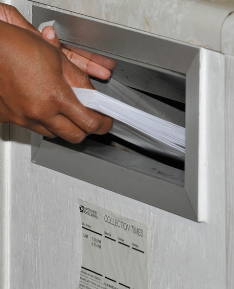 MOODY AIR FORCE BASE, Ga. -- An Airman drops letters off at the base post office Dec. 18 here. Due to the large number of Moody members currently deployed, the base post office has been busy in supporting the mail being sent overseas. (U.S. photo by Senior Airman Schelli Jones)
