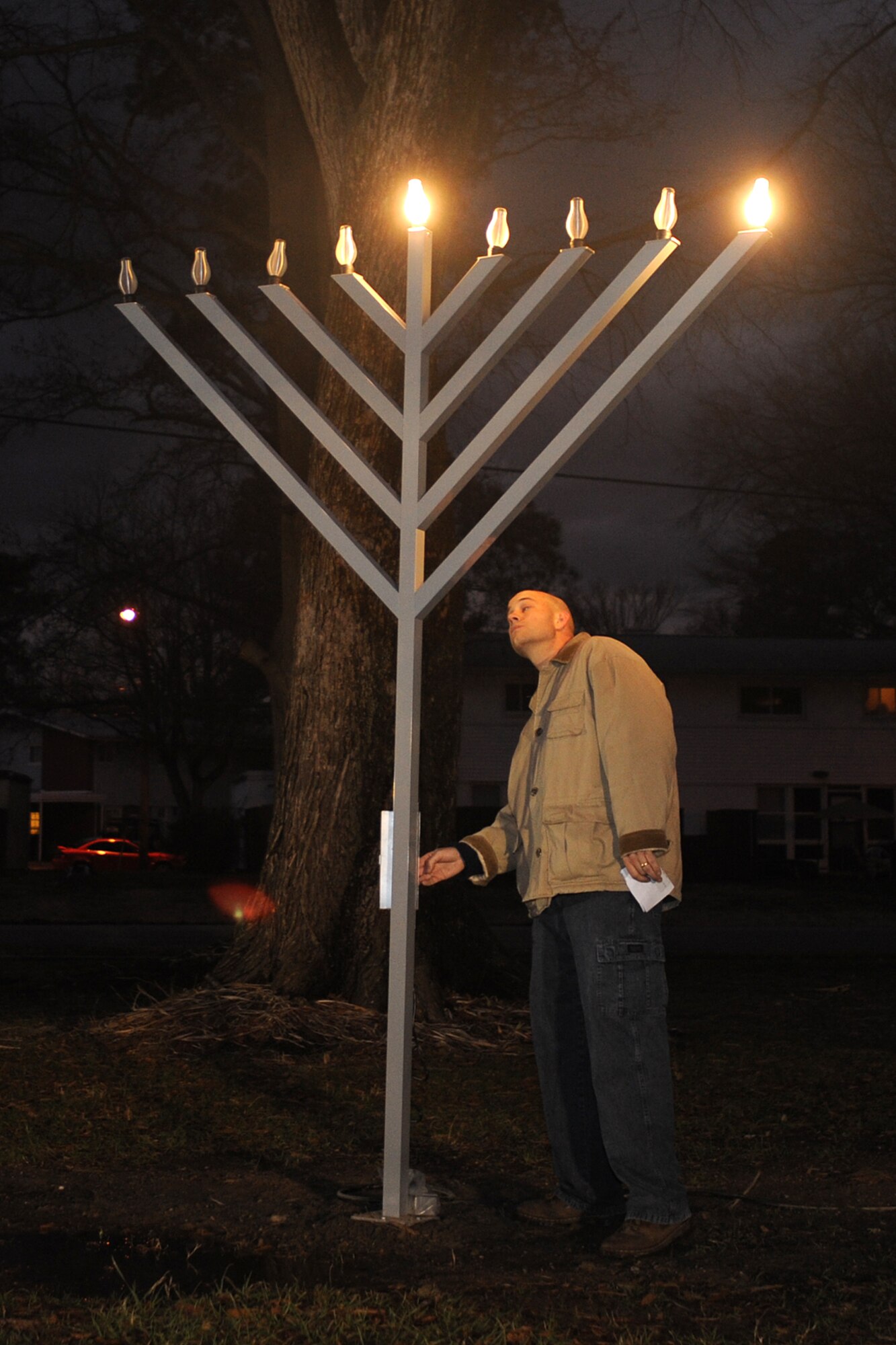 LANGLEY AIR FORCE BASE, Va.- Chaplin (Capt.) Clifford Jones lights the menorah during the annual Menorah lighting ceremony Dec 21. The Menorah is a symbol of the Hanukkah miracle in which a day's worth of oil burned for eight days and nights. During the celebration of Hanukkah, one candle is lit on each of the eight nights. (U.S. Air Force photo/Airman 1st Class Gul Crockett)