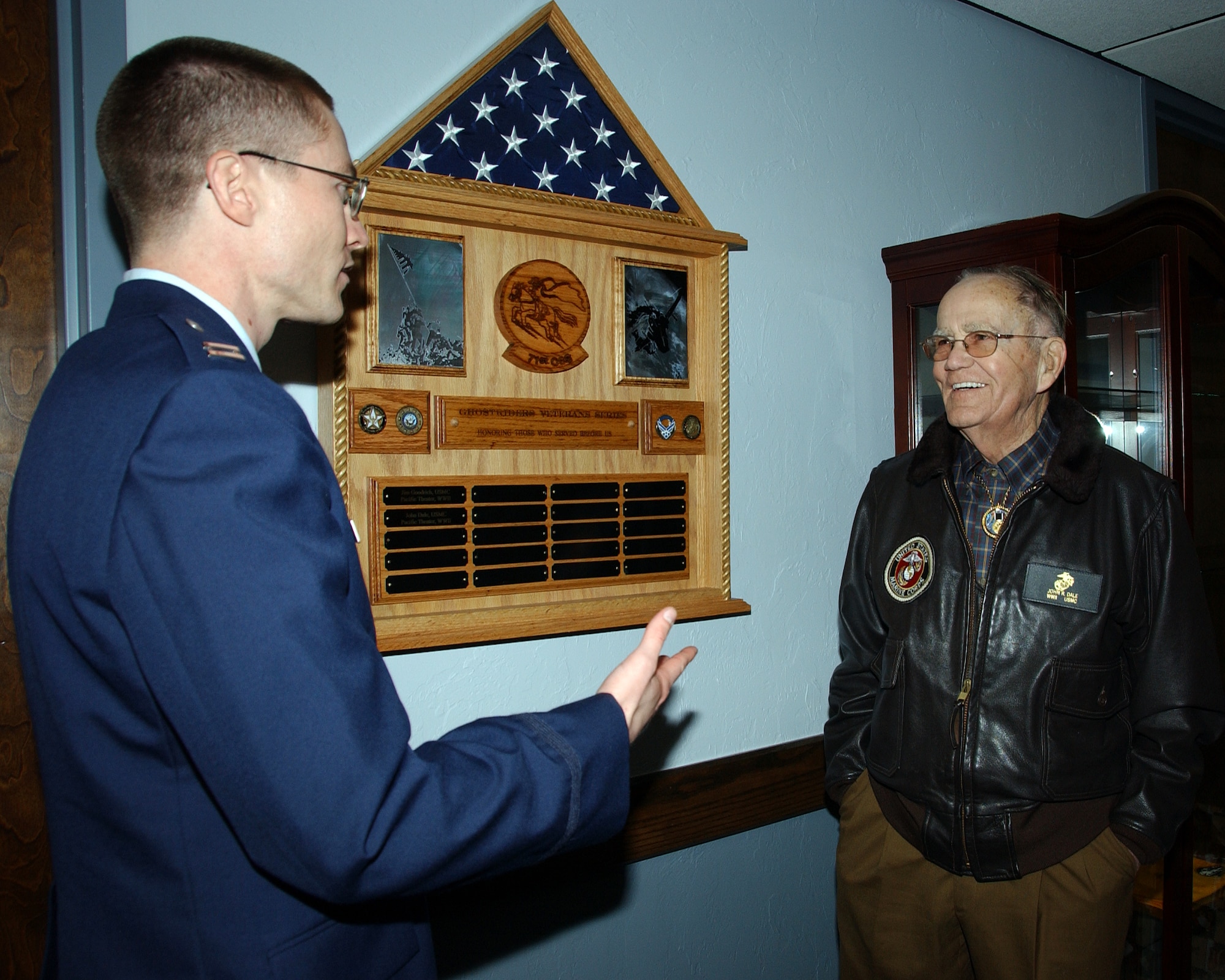 Capt. Jeremy Rose, left, presents Mr. John R. Dale with the plaque bearing his name, on display in the 71st Operational Support Squadron at Vance on Dec. 19 (U.S. Air Force photo by 2nd Lt. Lynn Aird).