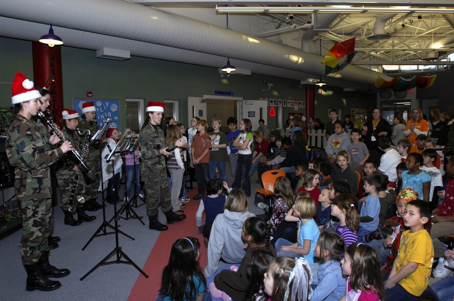 MINOT AIR FORCE BASE, N.D. — The Heartland of America Band New Horizons plays a holiday tune to children at the David C. Jones Youth Center to inspire holiday cheer here Dec. 17. The Heartland of America bands have delighted audiences’ since 1943 and continue to foster morale and esprit de corps to Airmen serving throughout the Air Force. (U.S. Air Force photo by Airman 1st Class Jesse Lopez)