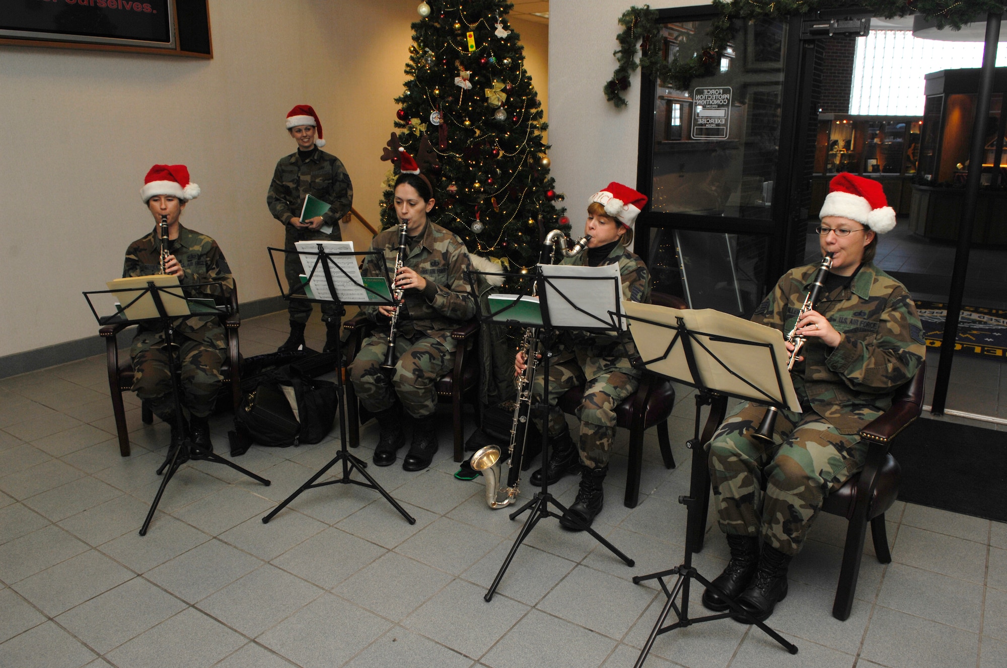 MINOT AIR FORCE BASE, N.D. -- The Heartland of America Band New Horizons plays a holiday tune to members of the 91st Missile Wing staff in the 91st MW headquarters building atrium to inspire holiday cheer here Dec. 17. The Heartland of America bands have delighted audiences’ since 1943 and continue to foster morale and esprit de corps to Airmen serving throughout the Air Force. (U.S. Air Force photo by Senior Airman Joe Rivera)