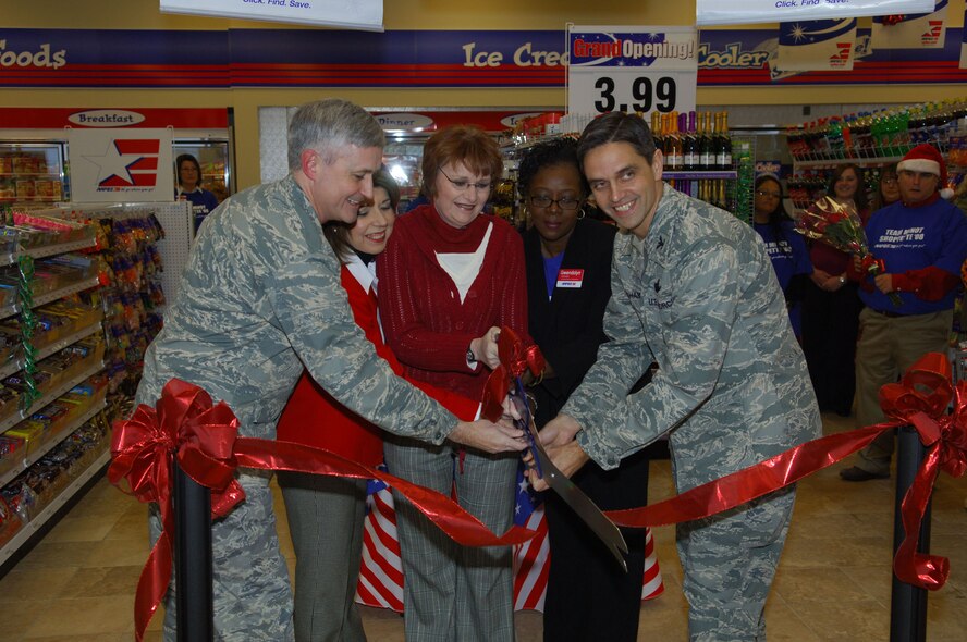 MINOT AIR FORCE BASE, N.D. -- Col. Michael Spencer, 91st Missile Wing vice commander (left), Trini Saucedo, Army and Air Force Exchange Service area manager (left center), Mae Padgett, AAFES general manager (center), Gwen Rowell, AAFES facility manager (right center), and Col. Steven Basham, 5th Bomb Wing vice commander (right), cut the ribbon during the grand opening ceremony for the new base shoppette here Dec. 19. The new, state-of-the-art $17 million facility is more than 19, 000 square feet and includes 24-hour operation, a replacement of the existing AAFES service station and an AAFES-operated car wash. (U.S. Air Force photo by Senior Airman Cassandra Jones)