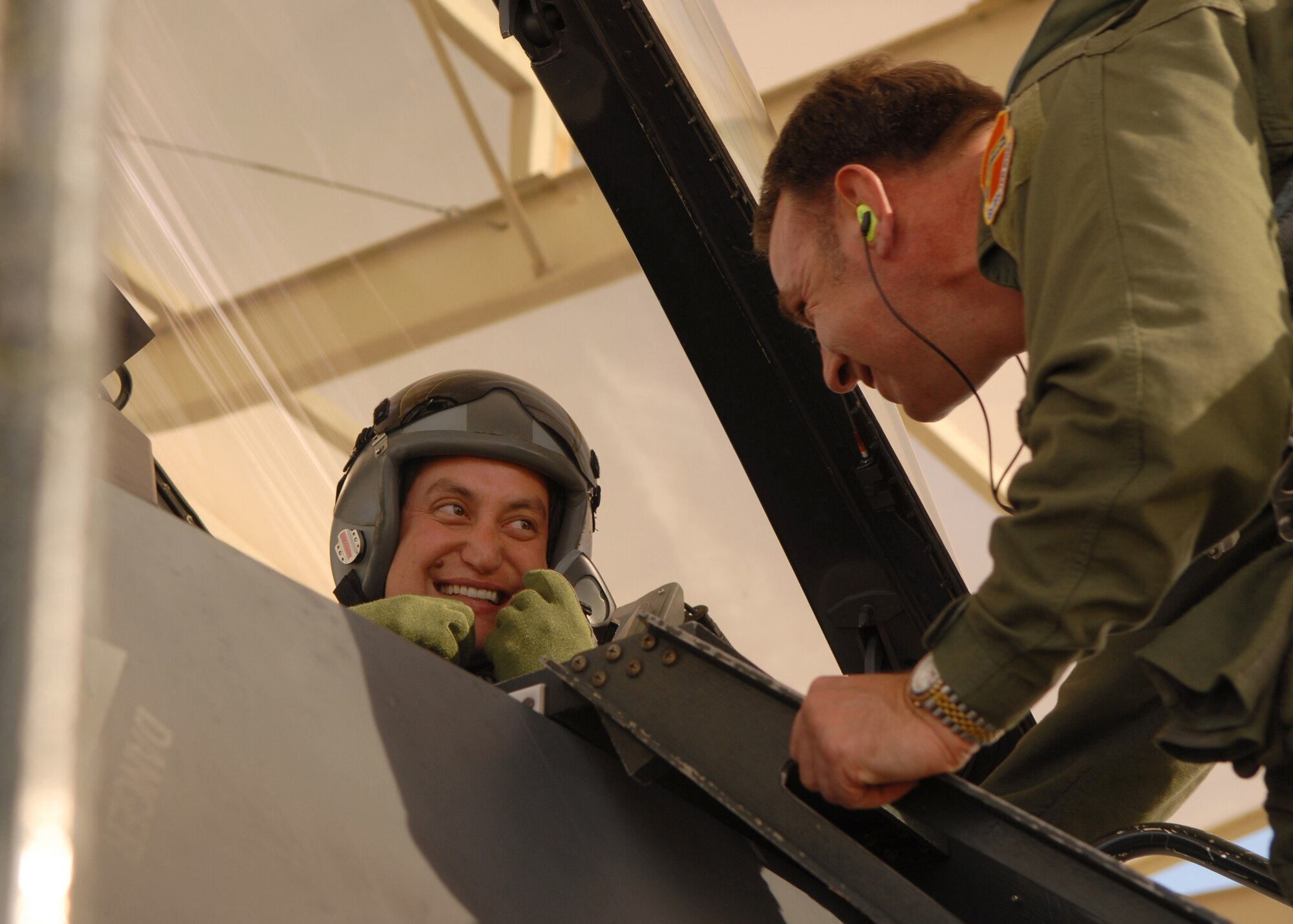 Colonel Hank Reed, 56th Fighter Wing vice commander (right), checks on his co-pilot Mr. Steve Yamamori, Executive Director and Chief Executive Officer of Fighter Country Partnership, during Mr. Yamamori's incentive flight Dec. 19.  The wing flies local dignitaries in order to better familiarize them with the Luke and Air Force mission. (U.S. Air Force photo/Airman 1st Class Ronifel Yasay)