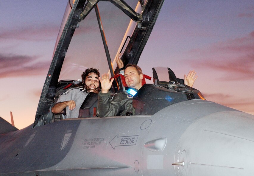TUCSON, Ariz. - 162nd Fighter Wing maintainers, security forces and fire department officials successfully thwart a simulated aircraft hijacking attempt during the last exercise of 2008. In the early morning hours of Dec. 11, Lt. Col. John Bobroski (left), Air Force Advisor, disguised himself as a perpetrator and attempted to taxi in an F-16 on the flightline here with Maj. Brant Putnam as his simulated hostage. (Air National Guard photo by Capt. Gabe Johnson)