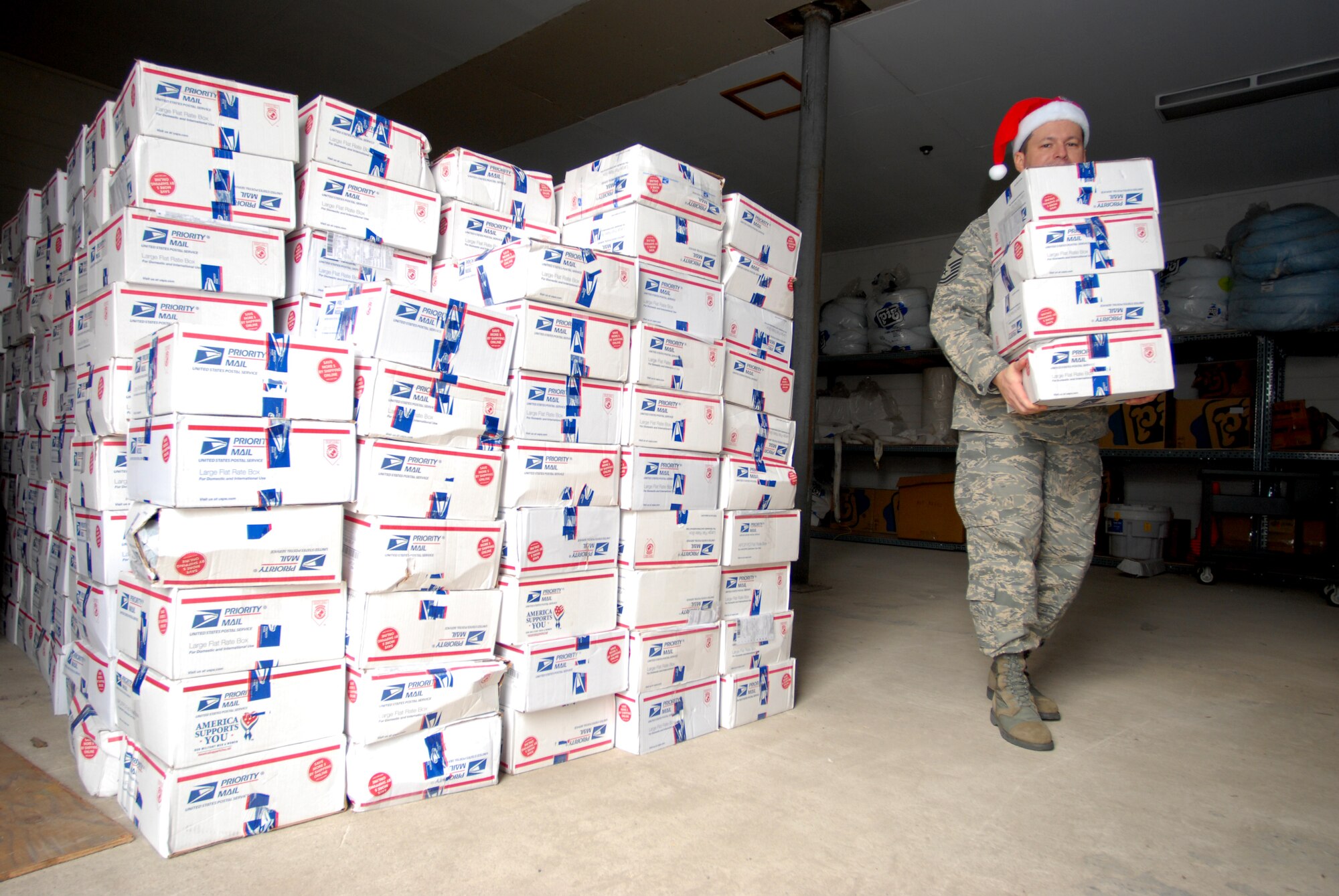 KUNSAN AIR BASE, Republic Of Korea -- Master Sgt. Michael Jones, 8th Force Support Squadron first sergeant, grabs gift packages to deliver to 8th FSS and 8th Fighter Wing staff Airmen here Dec. 24. Ms. Dona Neusbaum, mother of a former Wolf Pack member,  along with citizens of Lubbock, Texas, sent hand-made Christmas stockings and other gifts to every Airman at Kunsan. (U.S. Air Force photo by: Senior Airman Angela Ruiz)