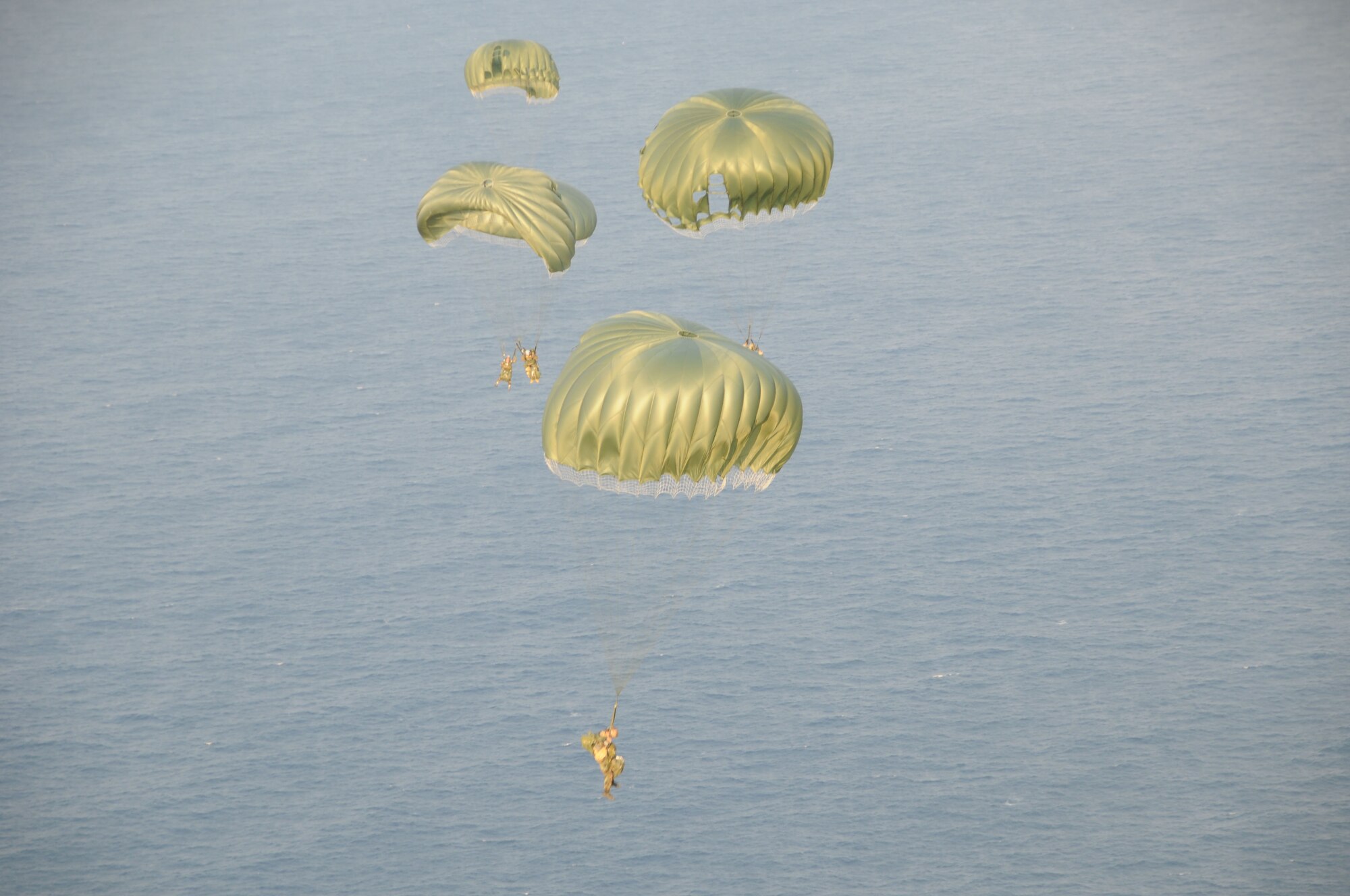 Pararescue specialists assigned to the 31st Rescue Squadron at Kadena Air Base, Japan float under canopy after conducting a static line jump from an MC-130P at 10,000 feet over Ie Shima during a training mission Dec. 16, 2008. The 17th Special Operations Squadron flew 21 pararescuemen for a series of static line and freefall jumps and refueled two HH-60s from the 33rd Rescue Squadron during the flight. (U.S. Air Force photo/Staff Sgt Chrissy Best)