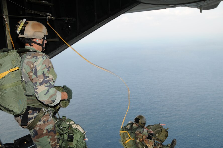 Pararescue specialists assigned to the 31st Rescue Squadron at Kadena Air Base, Japan float under canopy after conducting a static line jump from an MC-130P at 10,000 feet over Ie Shima during a training mission Dec. 16, 2008. The 17th Special Operations Squadron flew 21 pararescuemen for a series of static line and freefall jumps and refueled two HH-60s from the 33rd Rescue Squadron during the flight. Nine members of the 31st RQS recently deployed to Balad Air Base, Iraq in support of Operation Iraqi Freedom. (U.S. Air Force photo/Staff Sgt Chrissy Best). 