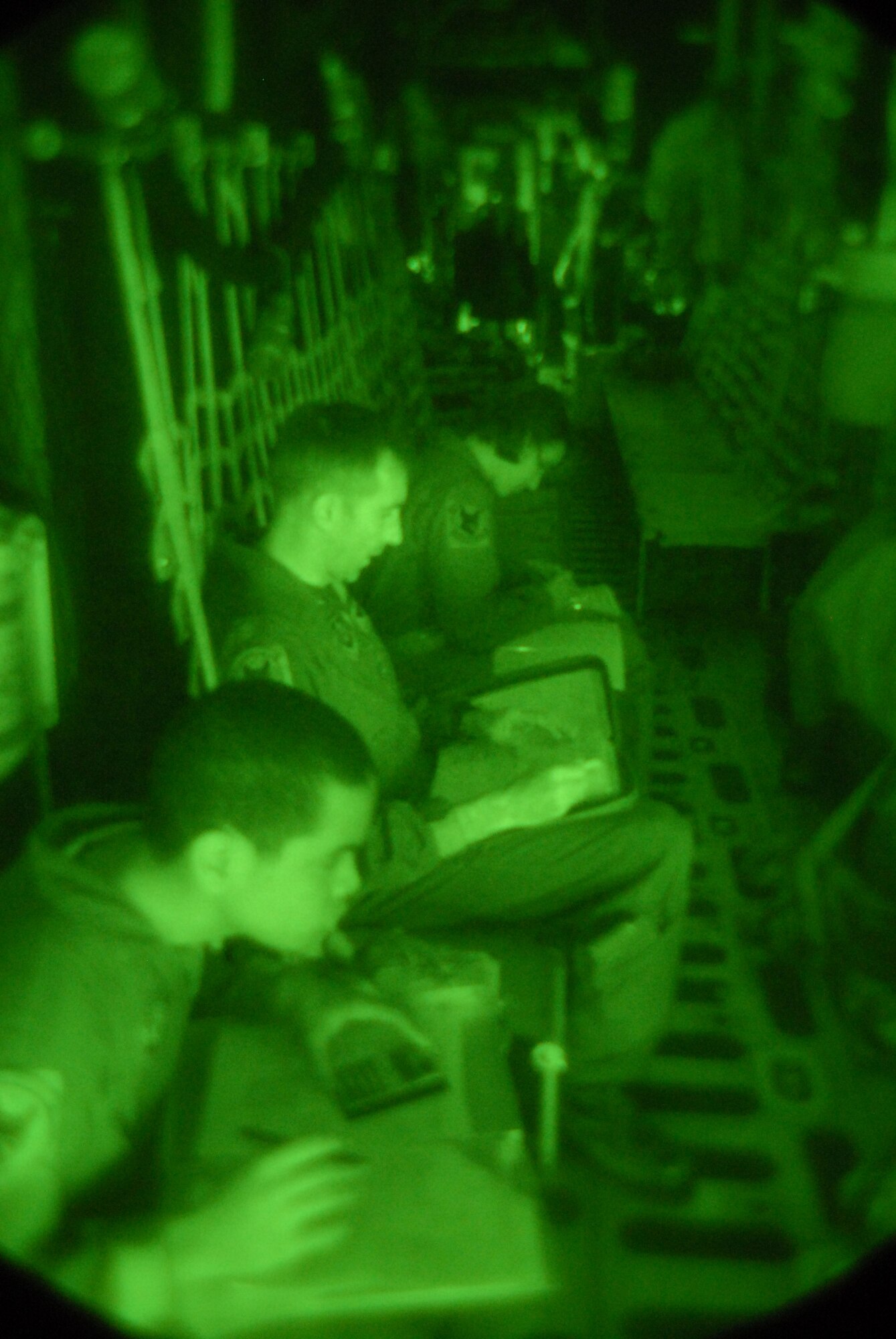 Airman 1st Class Jed Bilibei, MC-130P Loadmaster, Lt. Col. Andrew Clarke, MC-130P Pilot and Capt. Cassandra Moores, MC-130P Navigator, all assigned to the 17th Special Operations Squadron at Kadena Air Base, Japan, look over aircraft forms prior to a night training mission Dec. 16, 2008. U.S. Air Force photo/Staff Sgt Chrissy Best)