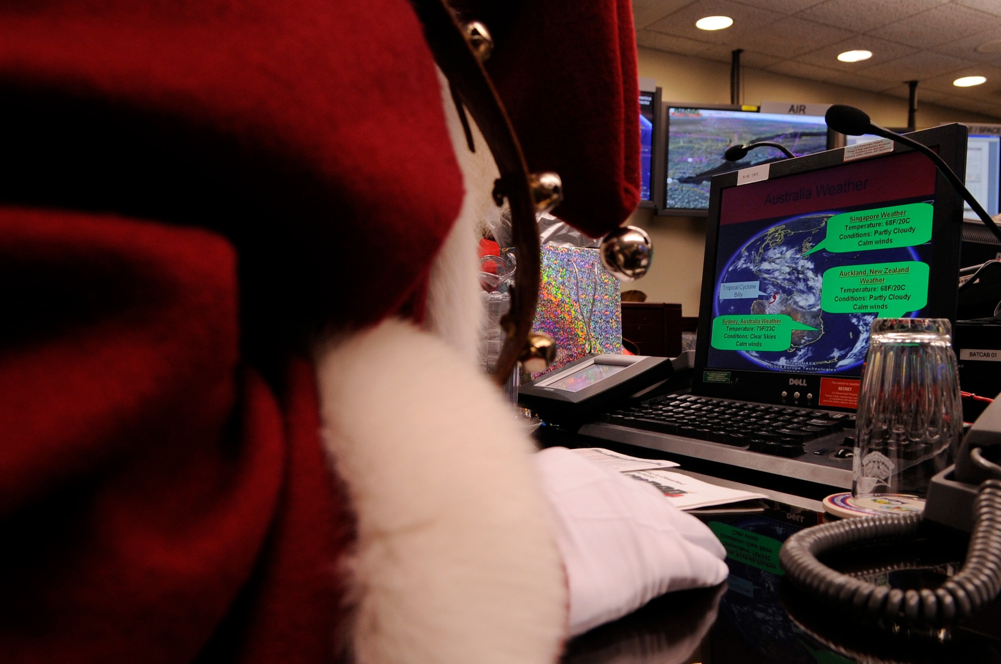 Santa Claus makes a surprise visit to the North American Aerospace Defense Command Tracks Santa Battle Cab Dec. 23 at Peterson Air Force Base, Colo. Santa received Federal Aviation Administration, weather and air mission briefs. (U.S. Air Force photo/Staff Sgt. Desiree N. Palacios) 

