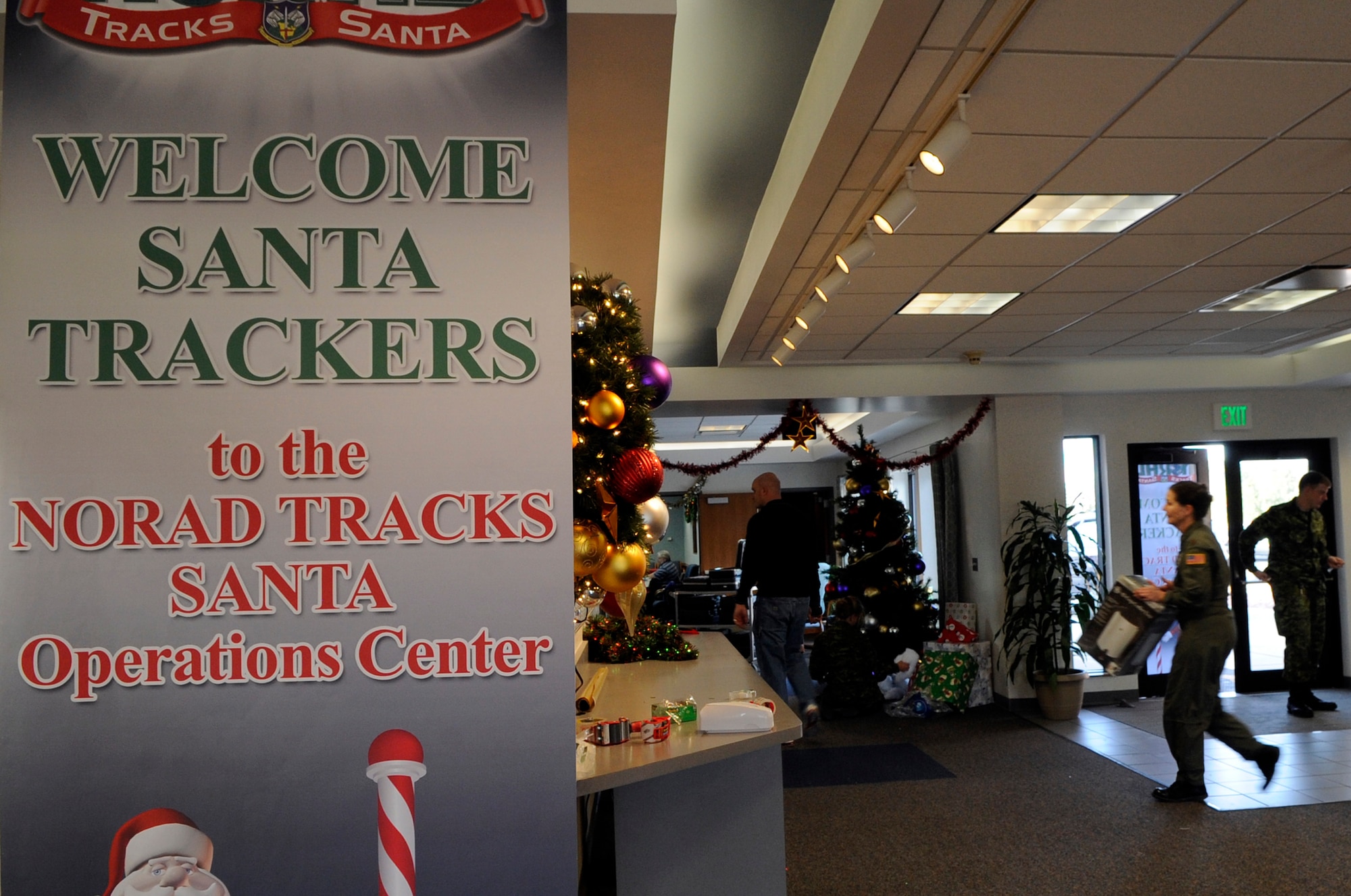 Military members from the U.S. and Canadian air forces help set up the North American Aerospace Defense Command Tracks Santa Operations Center Dec. 22 at Peterson Air Force Base, Colo. (U.S. Air Force photo/Staff Sgt. Desiree N. Palacios)