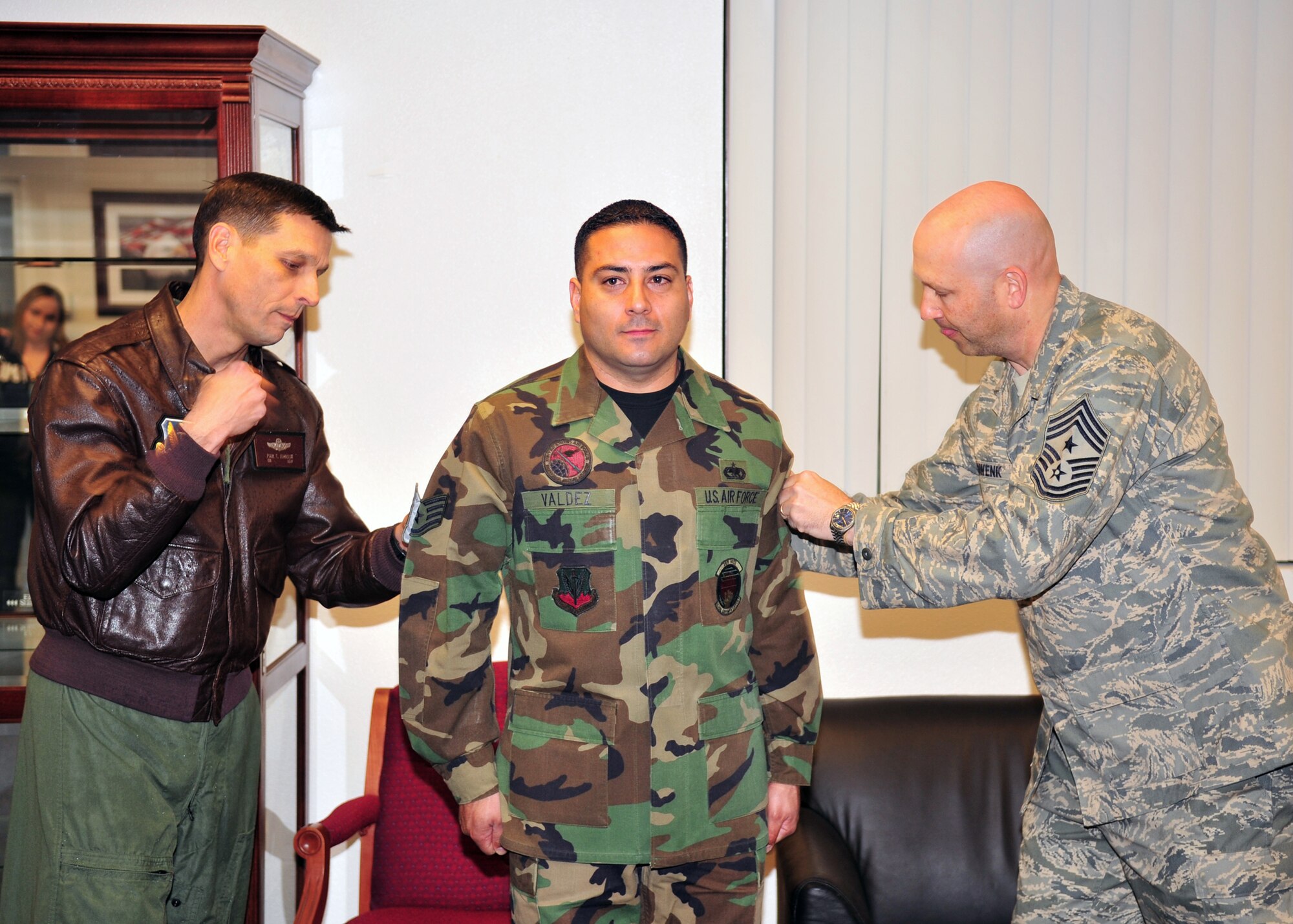 Col. Paul Johnson, 355th Fighter Wing commander, and Chief Master Sgt. Thomas Schwenk, 355th Fighter Wing Command Chief, pin Technical Sgt. stripes on STEP promotee Tech Sgt. Joseph Valdez, 355th Force Support Squadron Airman Leadership School Instructor here, Dec. 23. (U.S. Air Force photo/Senior Airman Noah R. Johnson)
