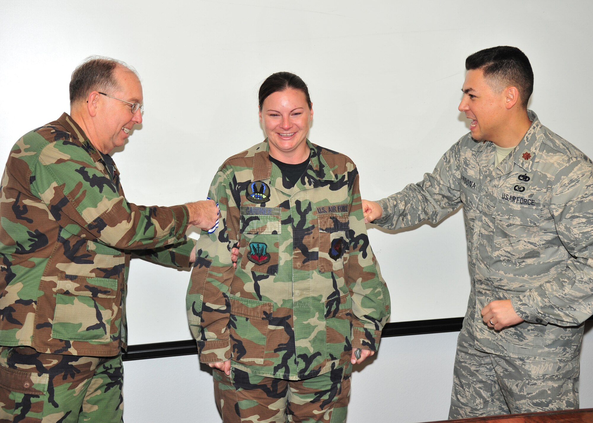 Col. Dennis Shumaker, 355th Maintenance Group commander, and Maj. Rudy Cardona, 355th Maintenance Operations Squadron commander, pin Technical Sergeant stripes on STEP promotee Tech Sgt. Crystal Gardner, 355th Maintenance Operations Squadron training manager here, Dec. 23. (U.S. Air Force photo/Senior Airman Noah R. Johnson)