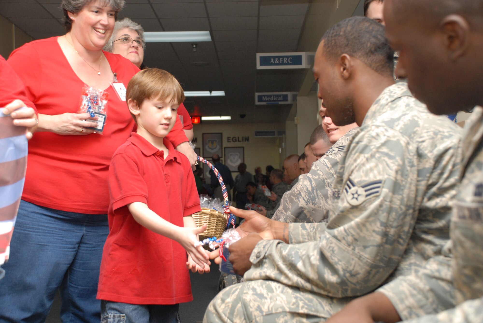 EGLIN AIR FORCE BASE, Fla. -- Samuel Cook, reaches out to shake hands with Senior Airman Jeff Howard, 20th Security Forces Squadron, Shaw Air Force Base, N.C., during a farewell event here Dec. 18. (U.S. Air Force photo by Staff Sgt. Mike Meares)