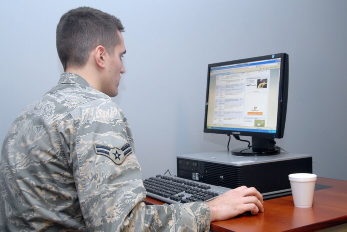 Airman 1st Class Jason Fricka uses the Internet on one of the new computers during the grand opening of the Dispersed Airmen?s Center on base Dec. 23. The Airmen Ministry Center/Internet Caf? was the first of four separate sections to open for the center. Airman Fricka is assigned to the 437th Civil Engineer Squadron. (U.S. Air Force photo/Staff Sgt. Marie Cassetty)